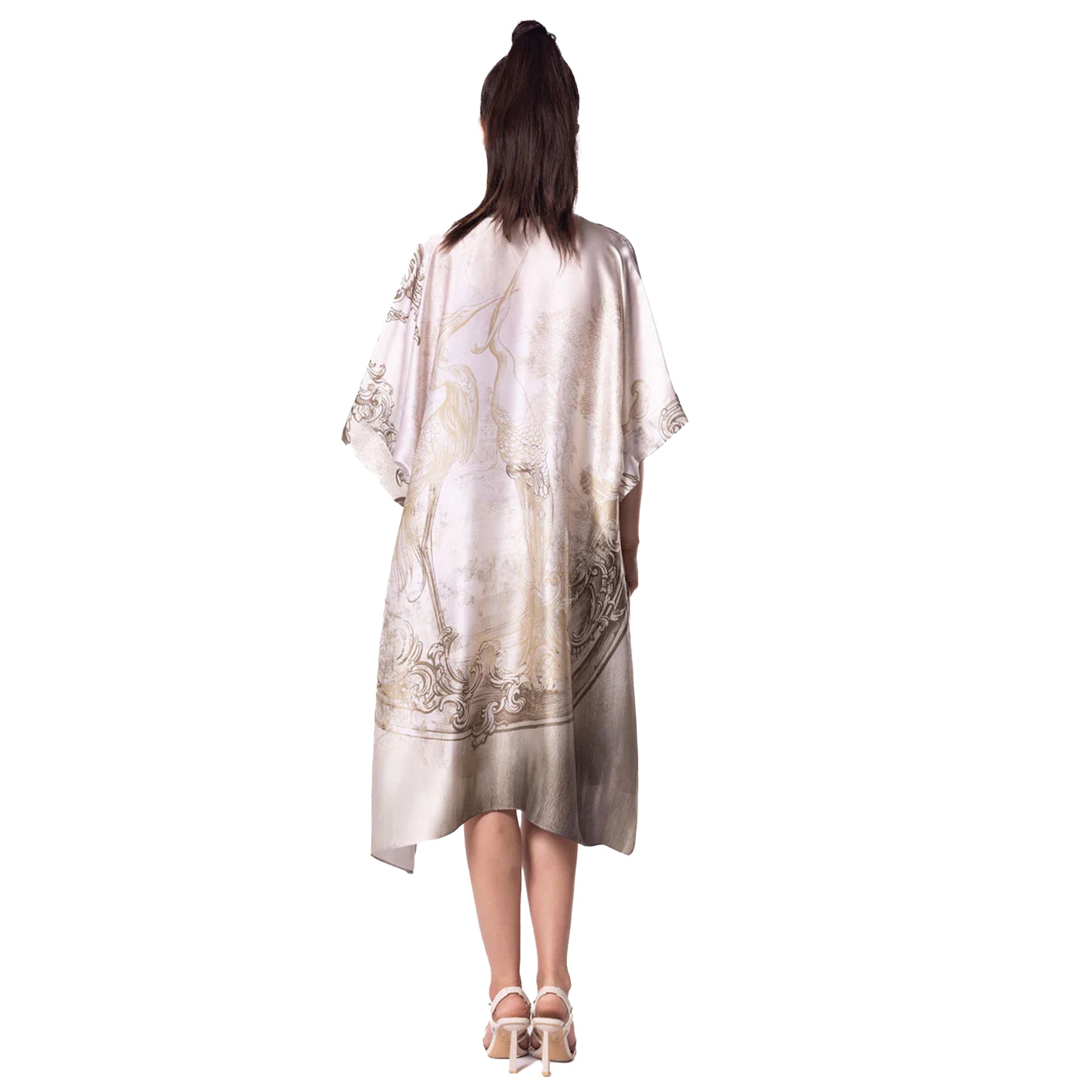 Back view of the satin robe showcasing a detailed crane and floral print in soft neutral tones.