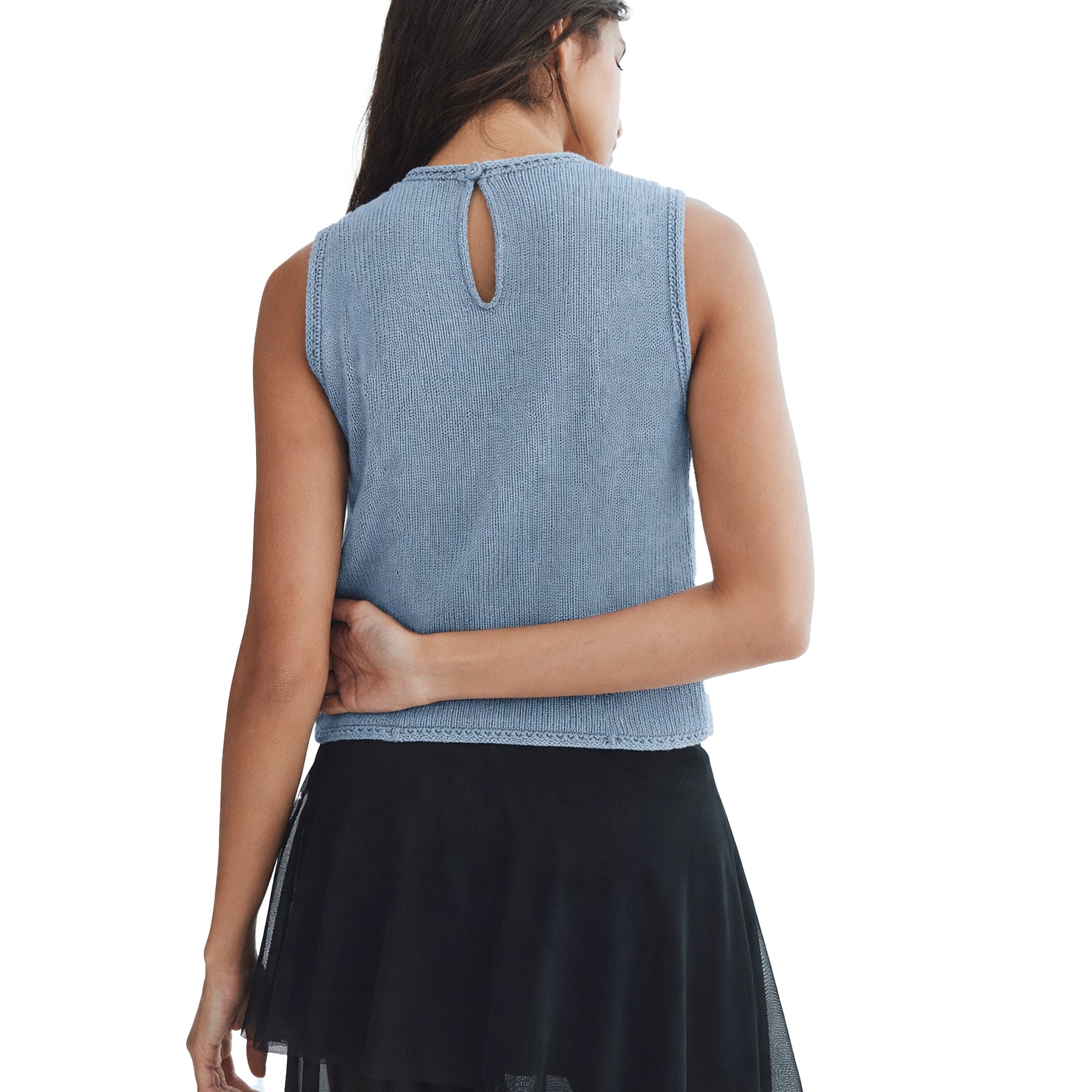 Back view of dusty blue sleeveless suede-effect top with keyhole button closure and crochet side panels worn by model.