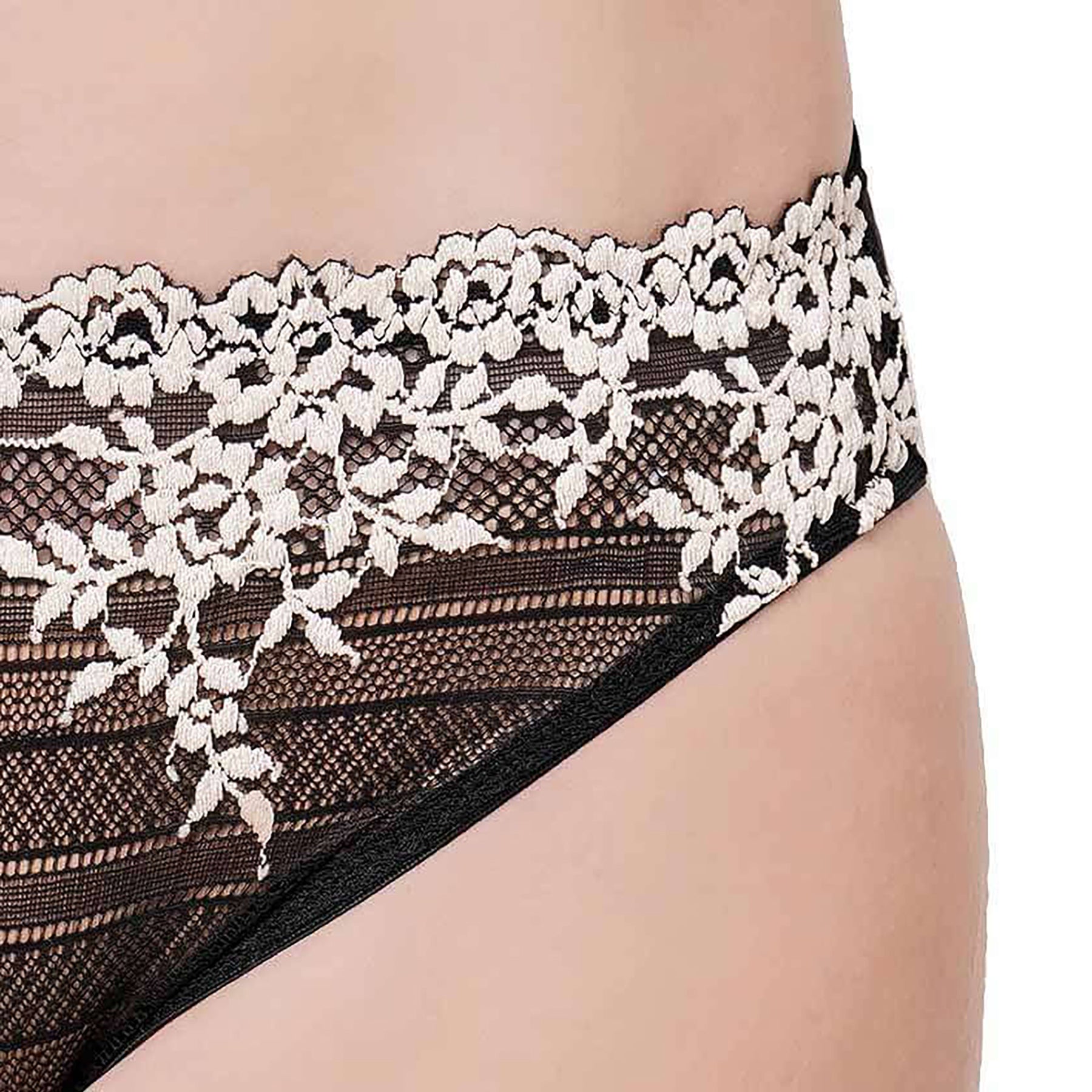Wacoal embrace lace bikini 64391. Mid-rise sheer black mesh panty with cream lace embroidery details. Front view close up on model.