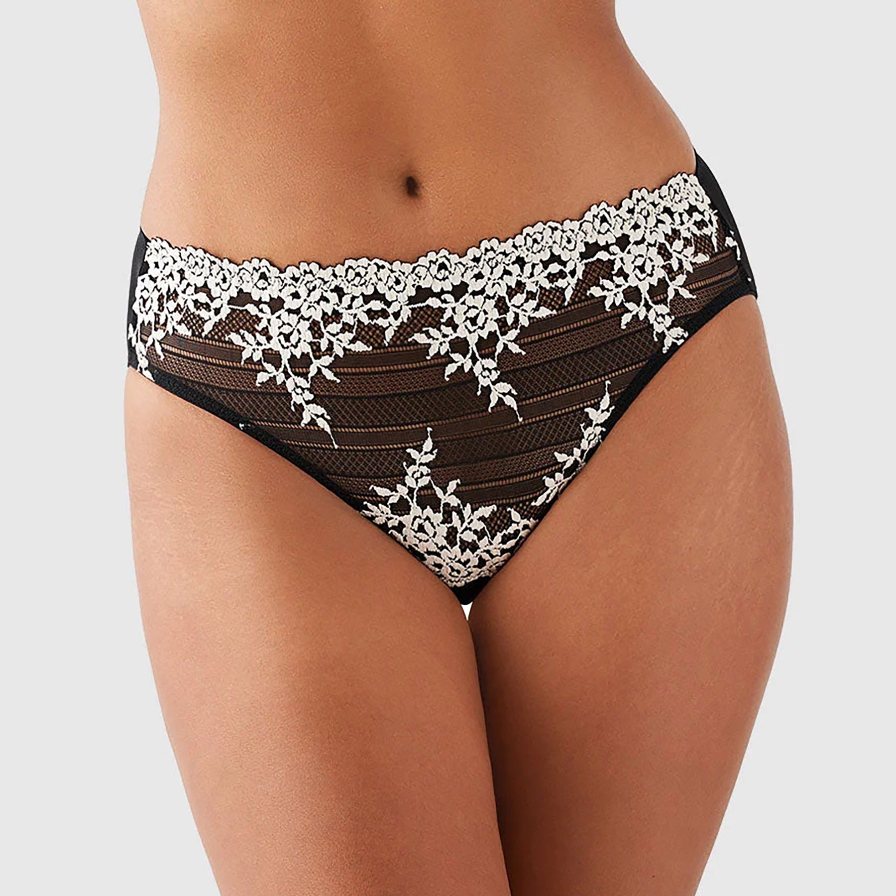 Wacoal embrace lace high waist sheer black mesh brief 841191 with cream lace embroidery details. Front view close up on model.