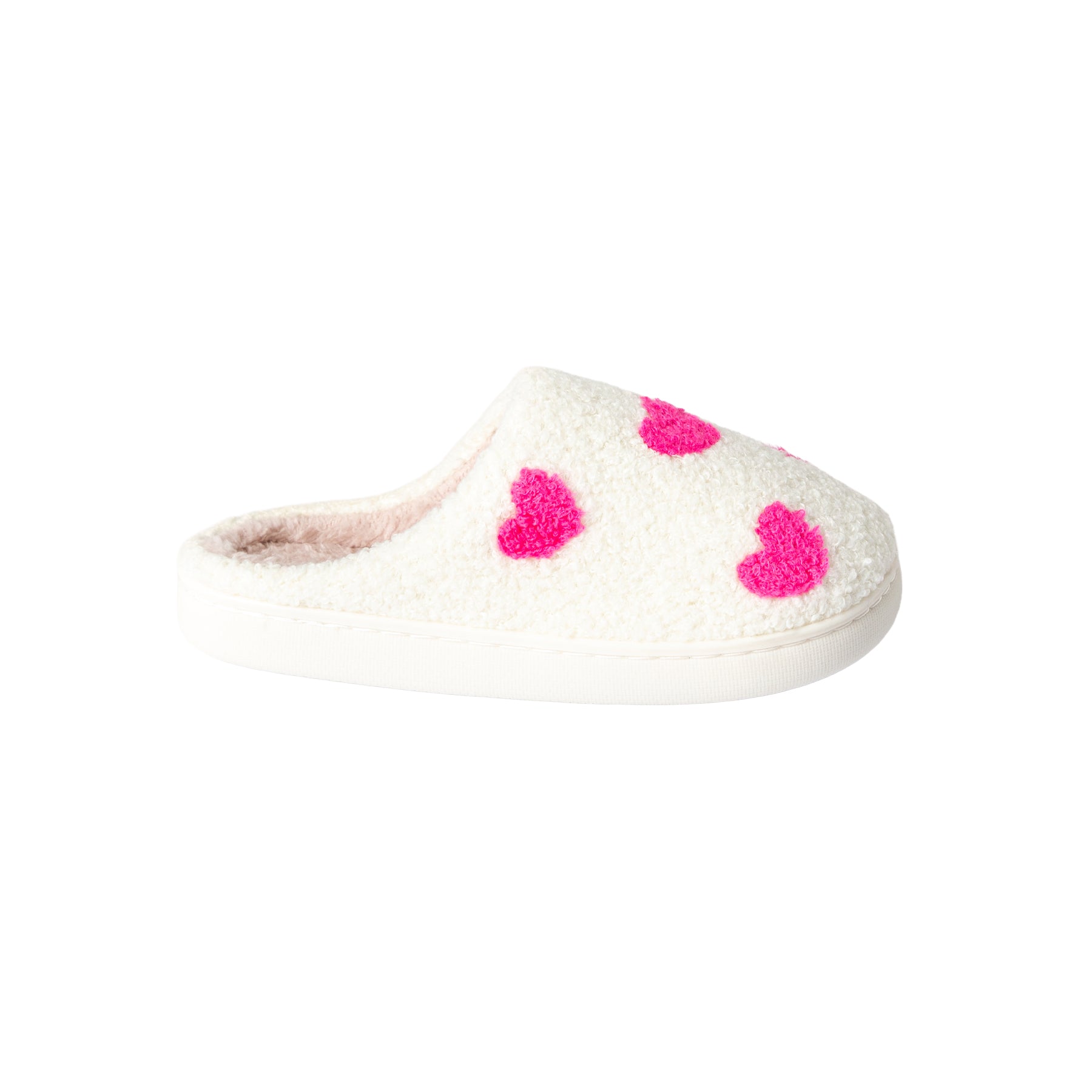 Top view of a pair of women's cream sherpa slippers with bold pink heart print, cozy blush-toned plush lining, and closed-toe mule design.