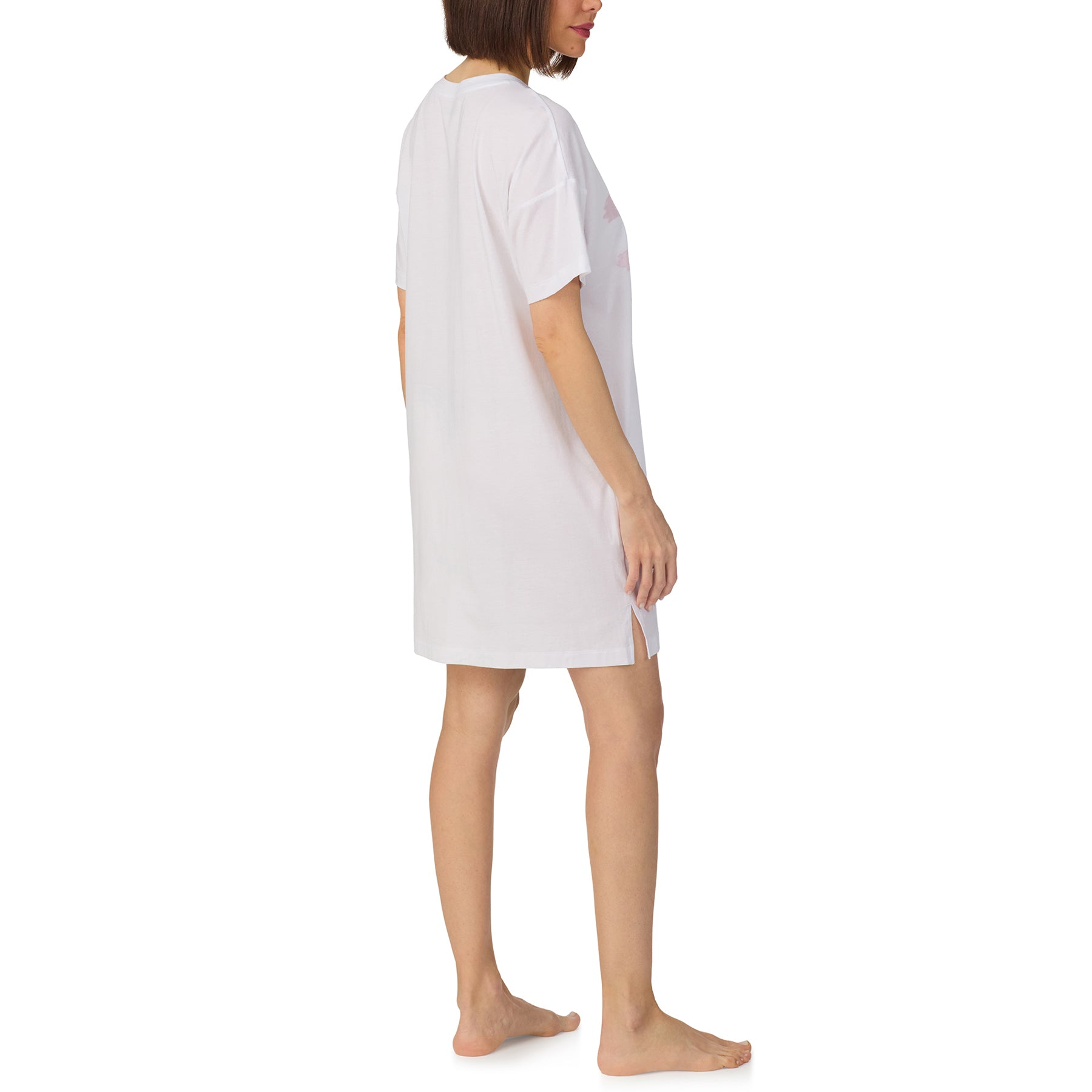 Side view of white cotton sleep shirt dress with loose fit and graphic print detail.