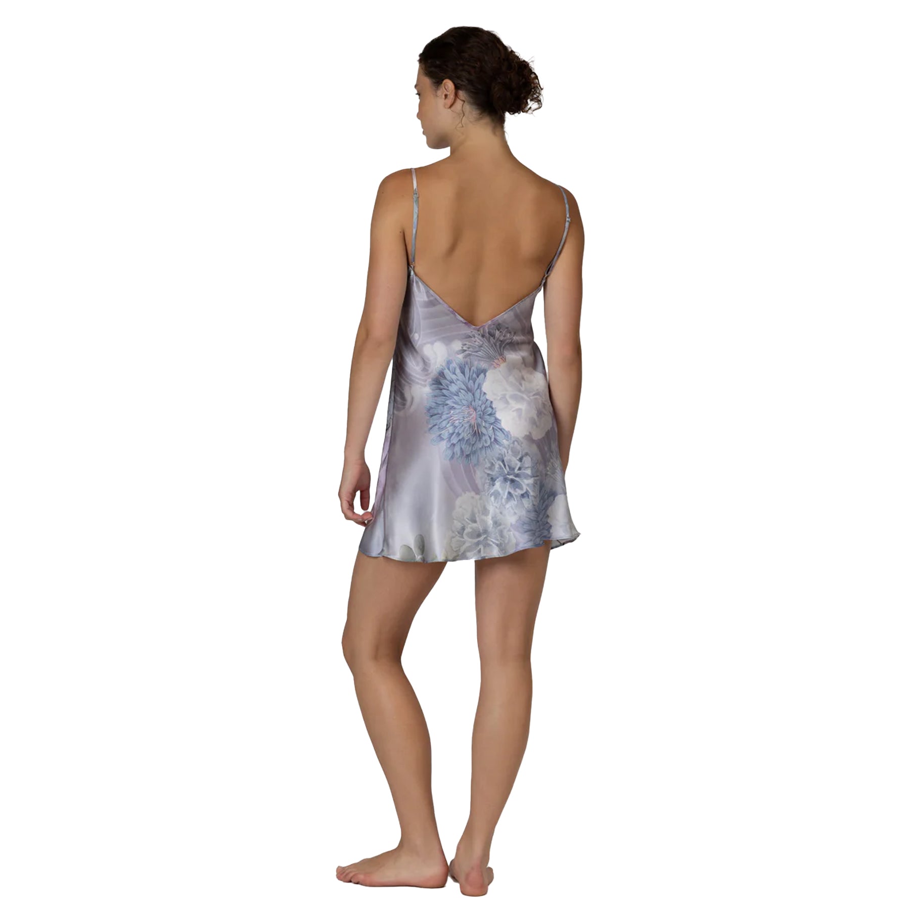 Back view of satin slip dress with floral print in muted blue and grey tones, low back silhouette
