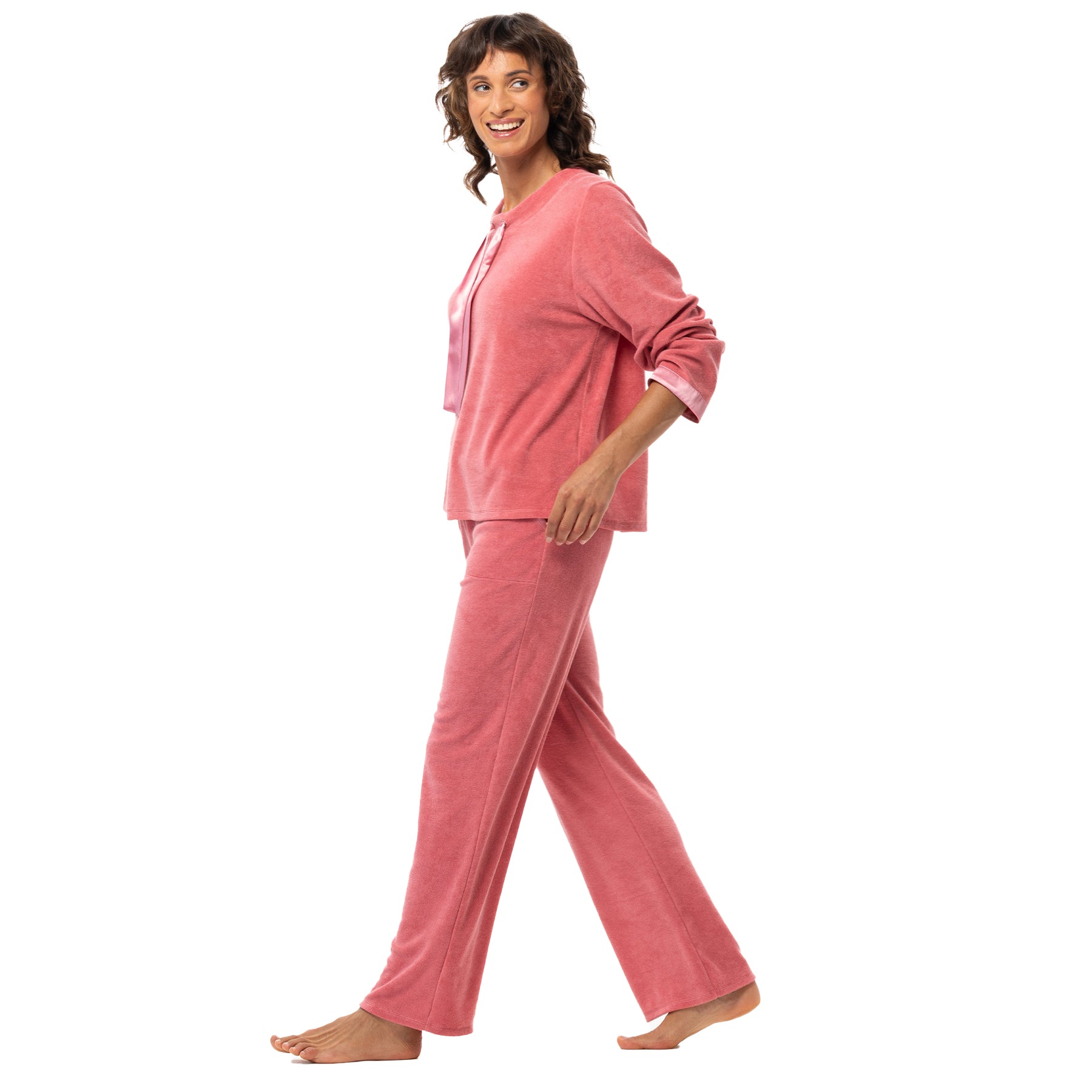 Model walking in pink velour lounge set with relaxed fit top and wide-leg pants