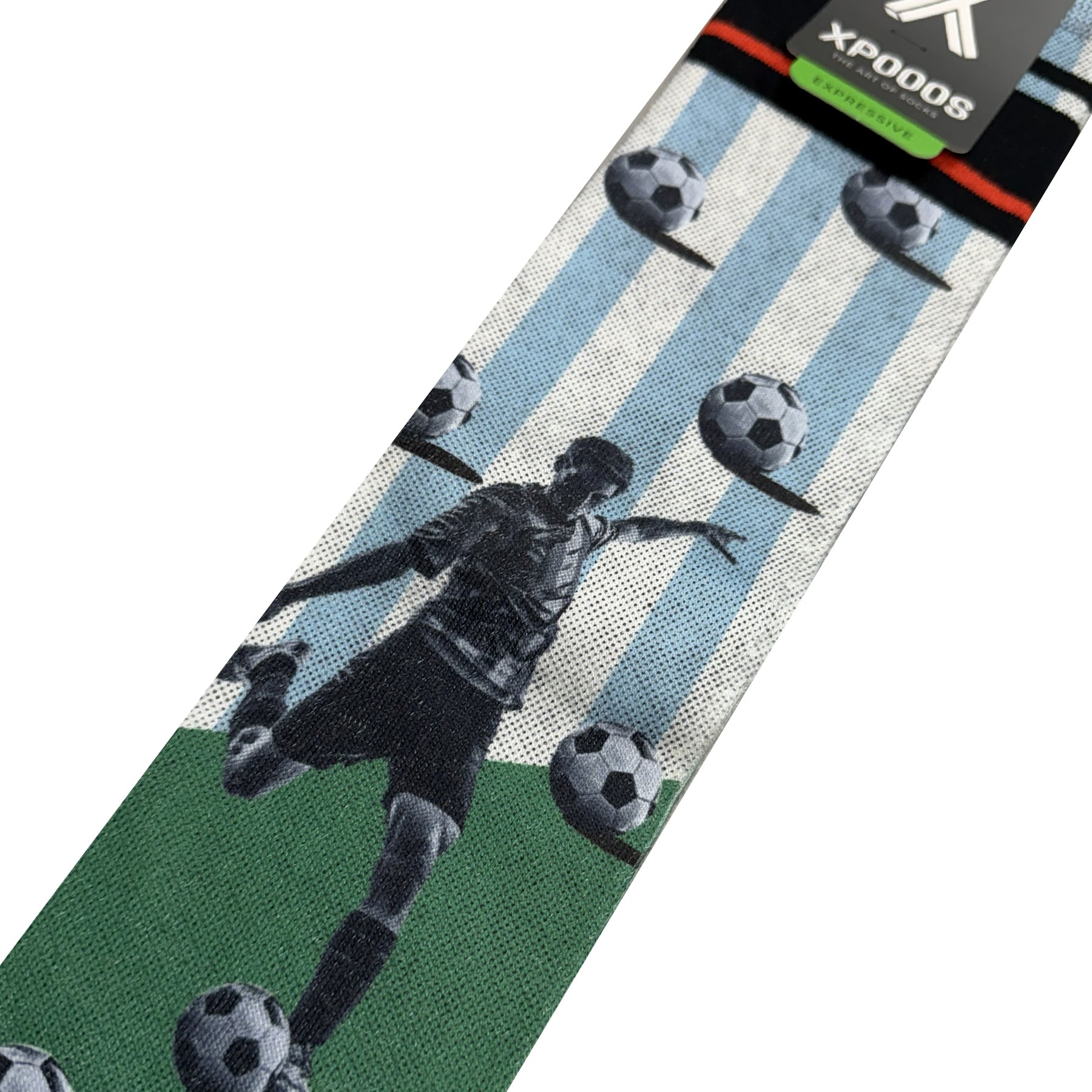 Close-up of men’s football-themed socks showing player kicking ball on green field with vertical blue and white stripes and black cuff detail.