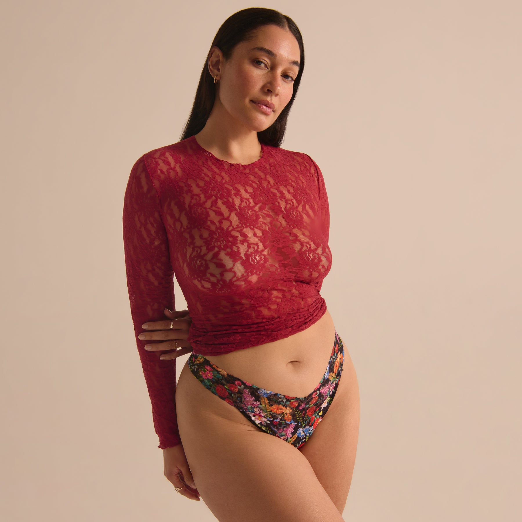 Model in sheer red lace top styled with the Hanky Panky Hypnotic floral lace thong.