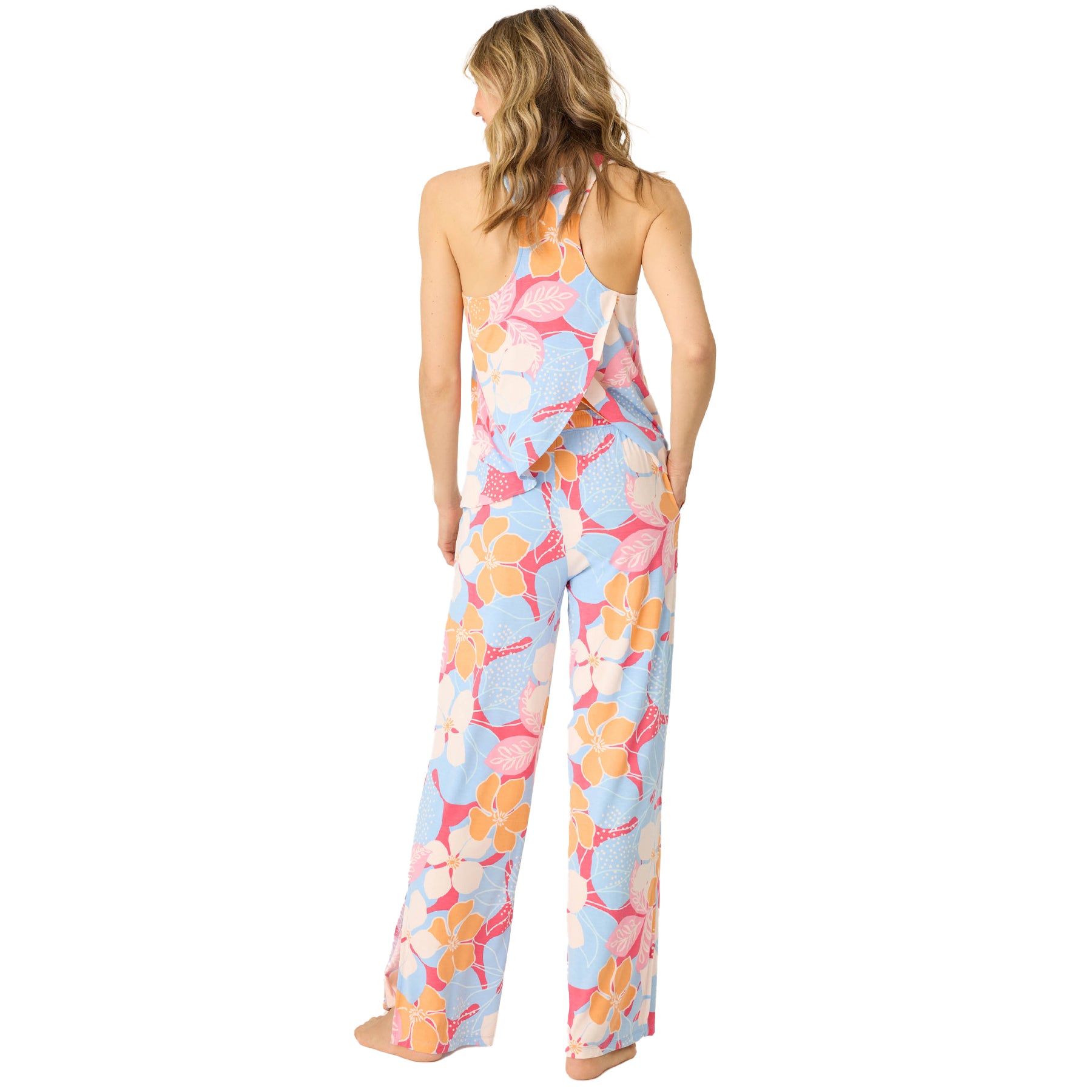 Back view of a woman wearing a tropical floral print tank top and wide-leg pajama pants.