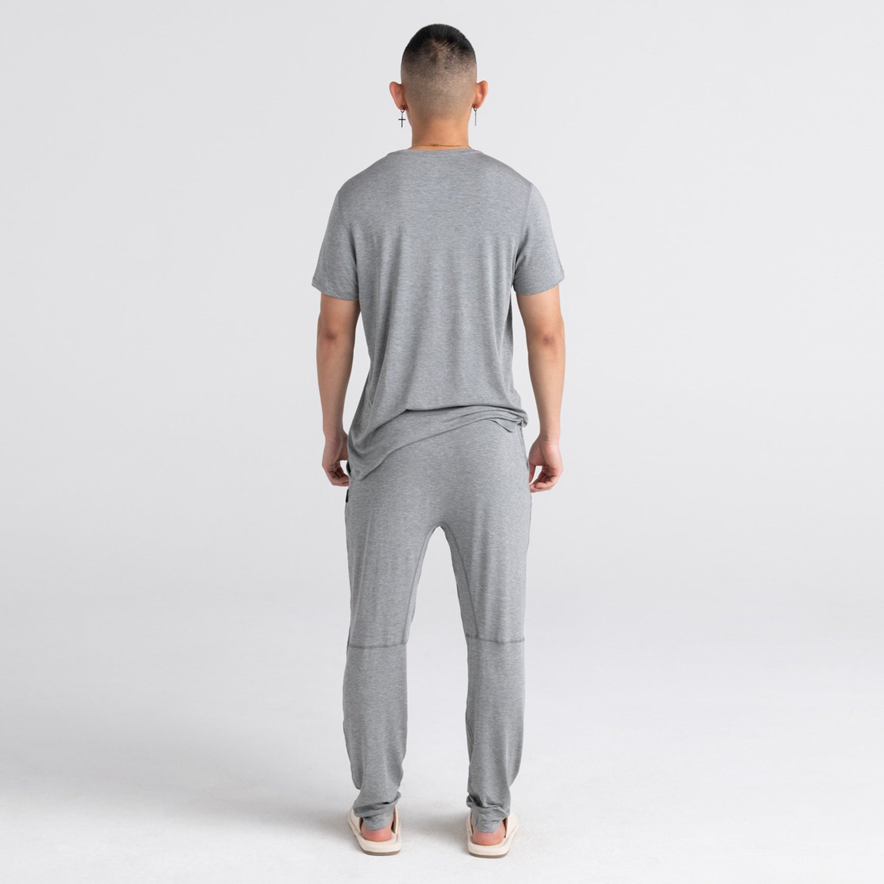 Grey lounge pants shown from the back with relaxed fit and tapered legs.