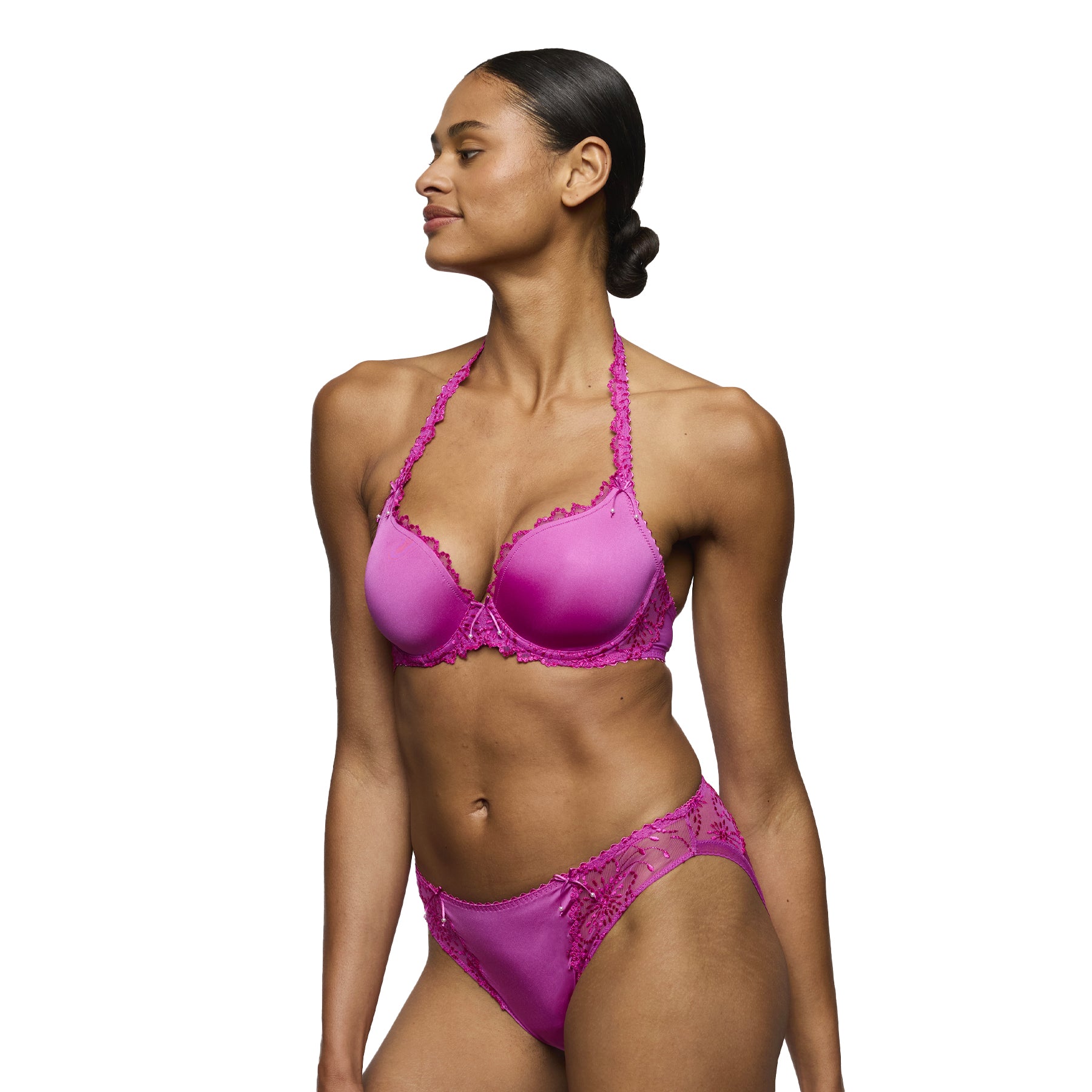 Three-quarter view of fuchsia lace underwire bra with smooth cups and matching briefs worn on model.