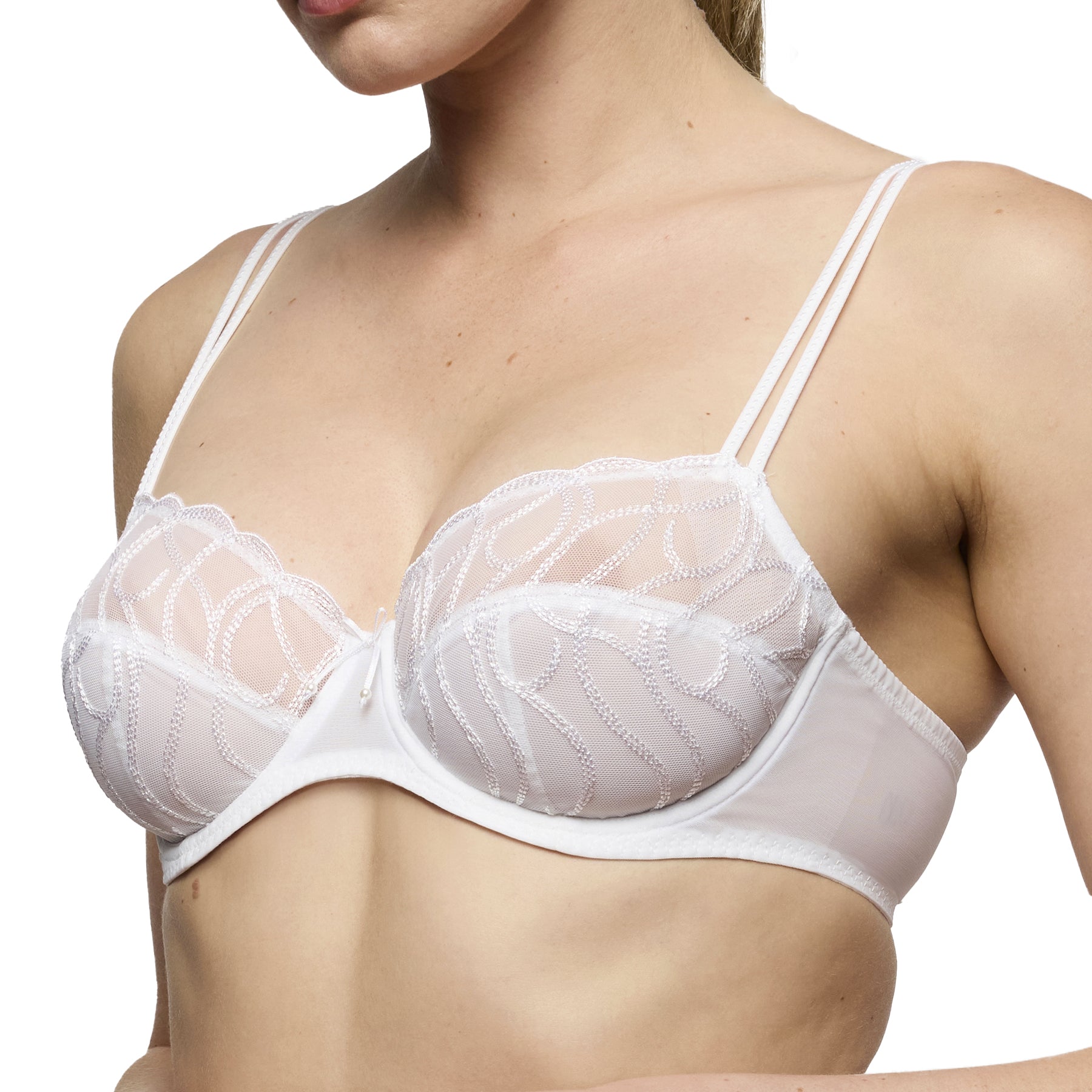 Side angle view of white balconette bra with semi-sheer embroidered cups and smooth supportive band on model.