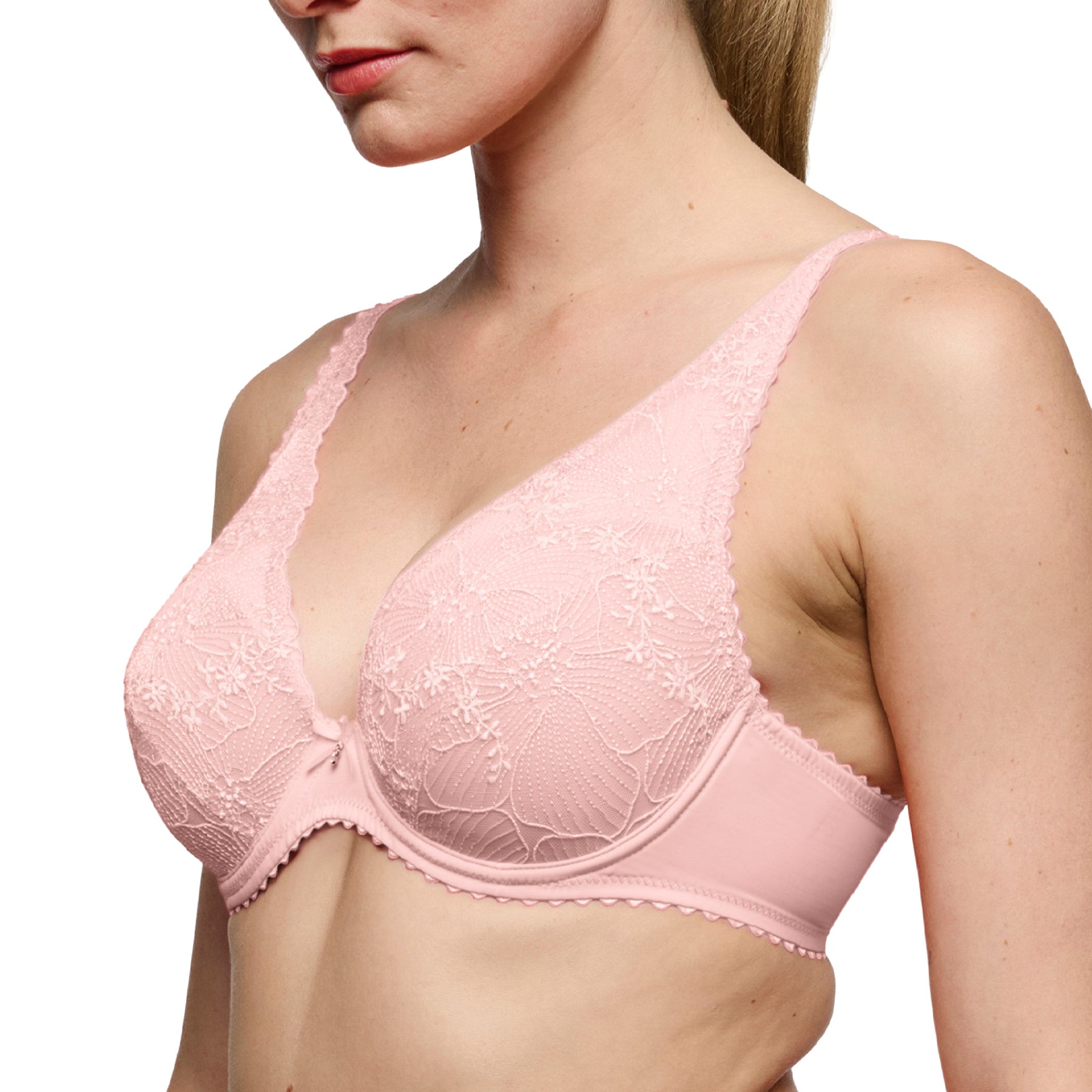 Three-quarter side view of a blush pink plunge bra showcasing embroidered lace cups, supportive underwire, and smooth microfiber wings.