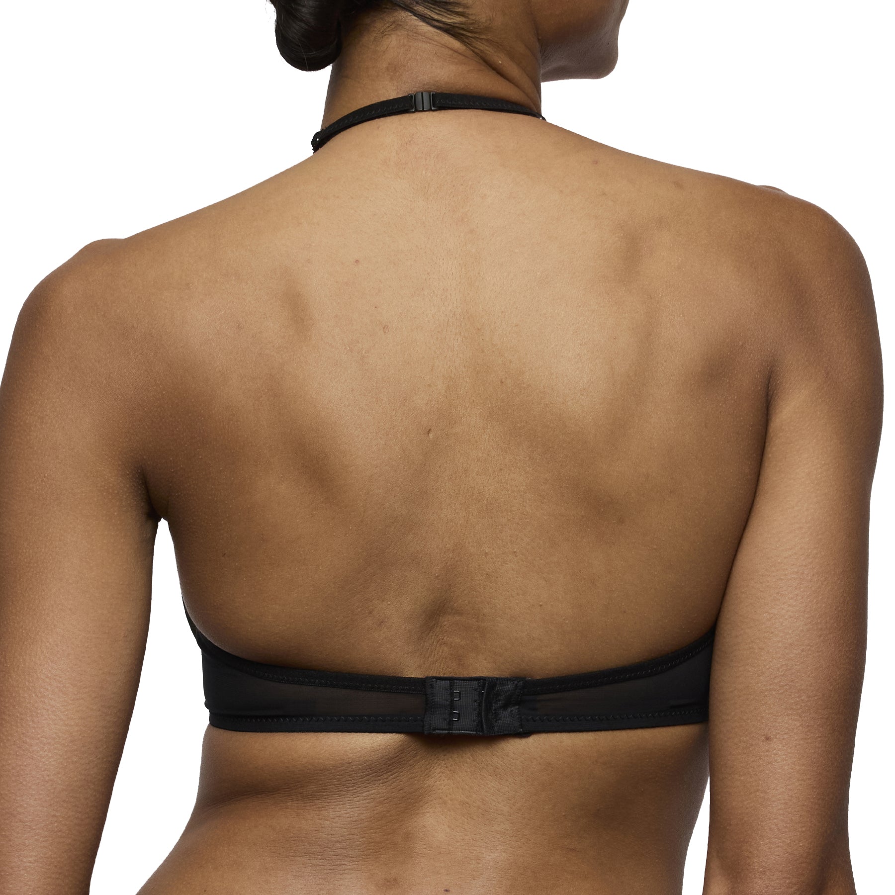 Back view of the black halter bra displaying the adjustable halter strap and hook-and-eye band closure.