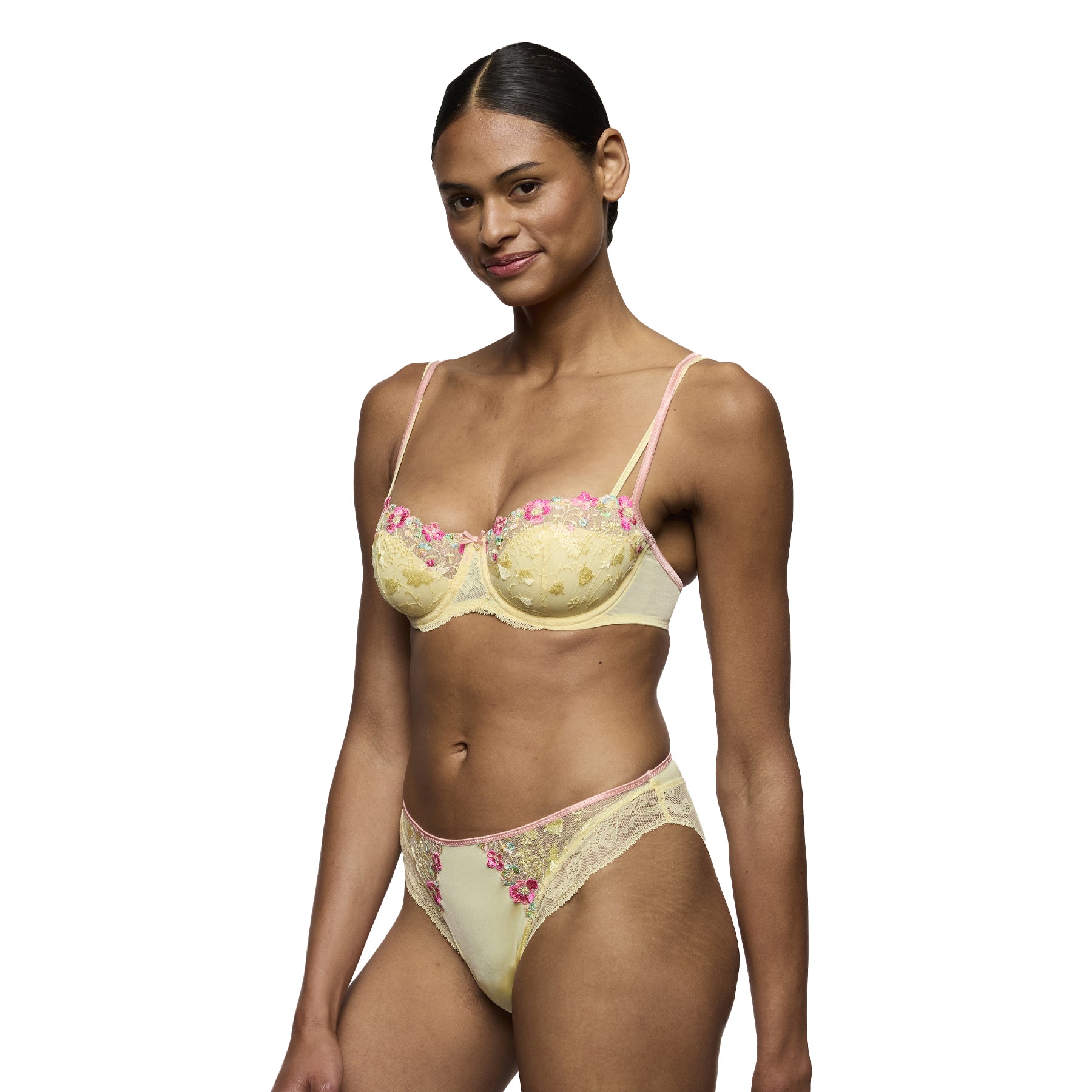 Model wearing French vanilla balconette bra with pink floral embroidery and matching bikini brief.