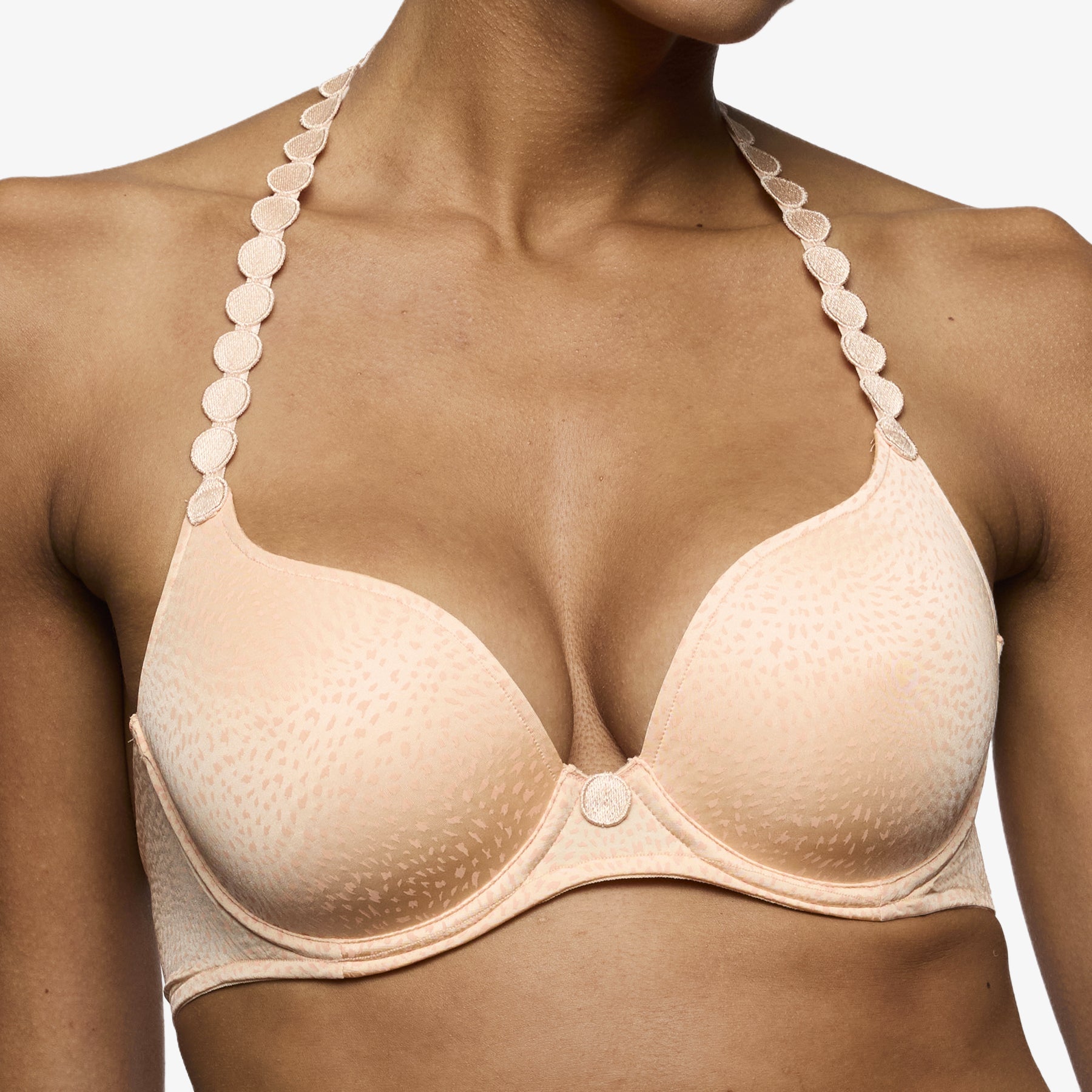 Peach plunge bra close-up with deep neckline and soft moulded cups