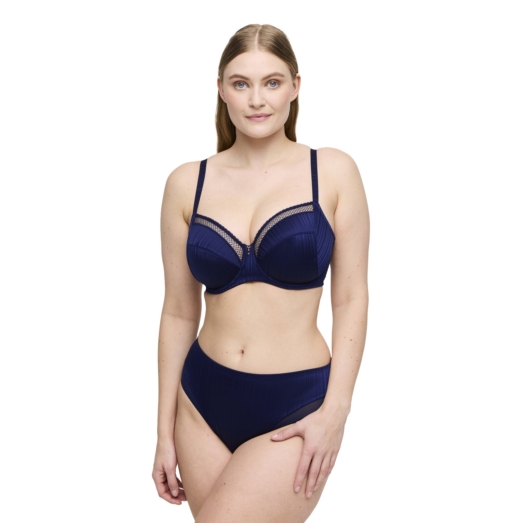 Woman wearing a sapphire blue bra and matching panties with pleated fabric and mesh detailing.