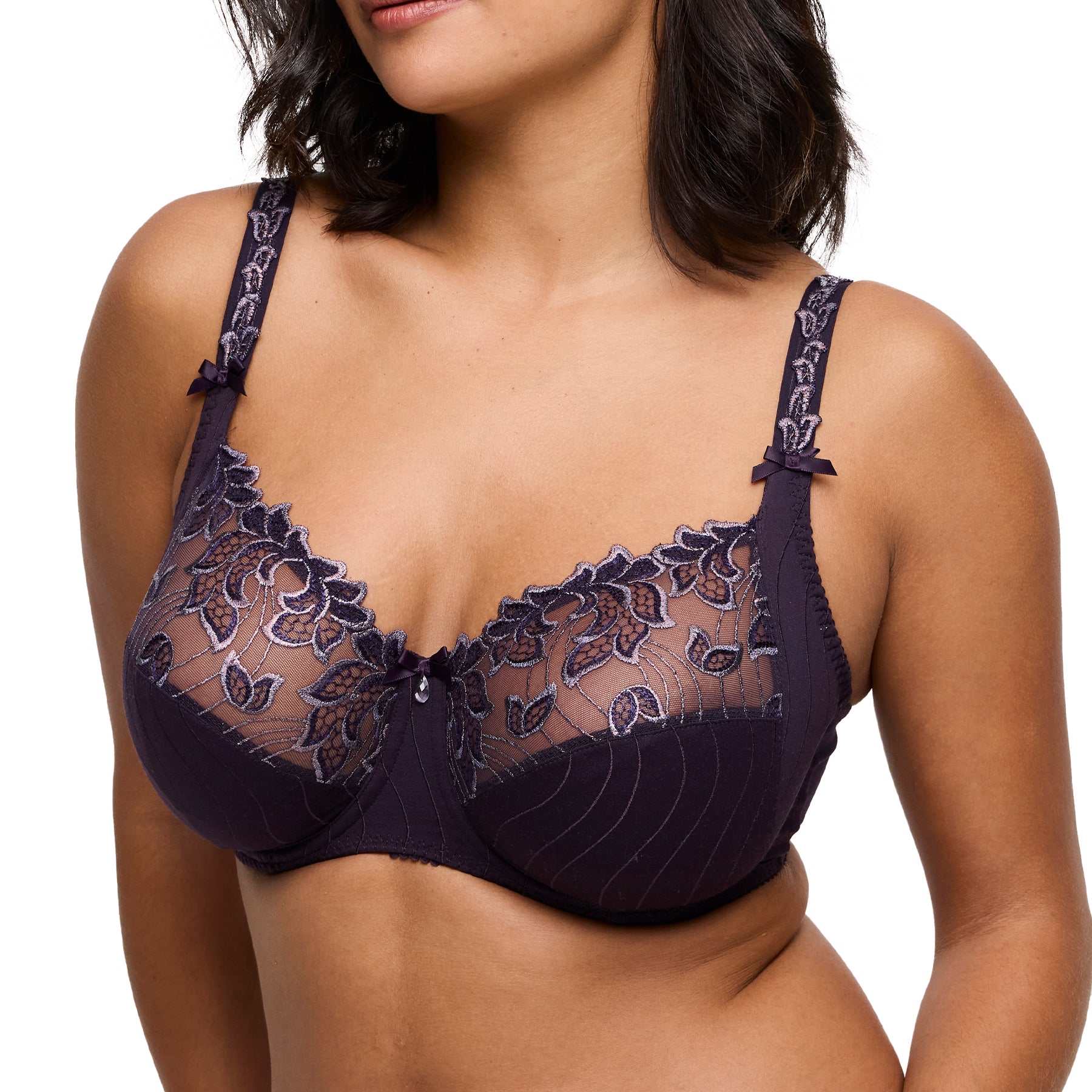 Close-up angled front view of model wearing deep plum full cup bra with floral embroidery.