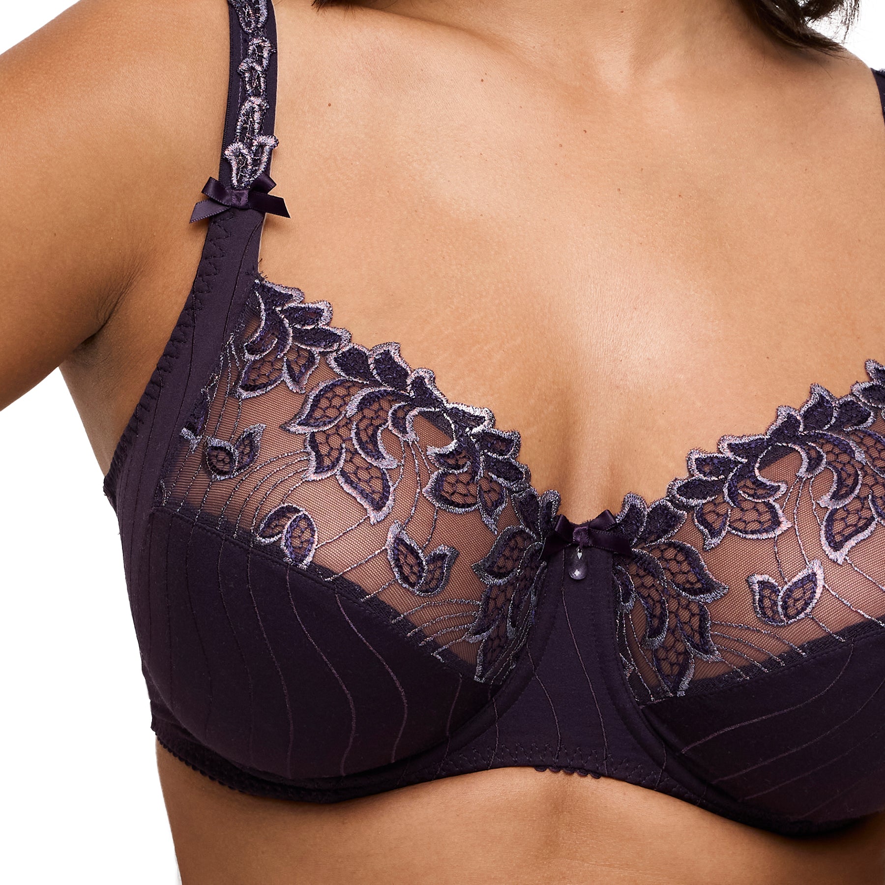 Close-up of bra cup showing intricate floral embroidery and sheer mesh panel in plum.