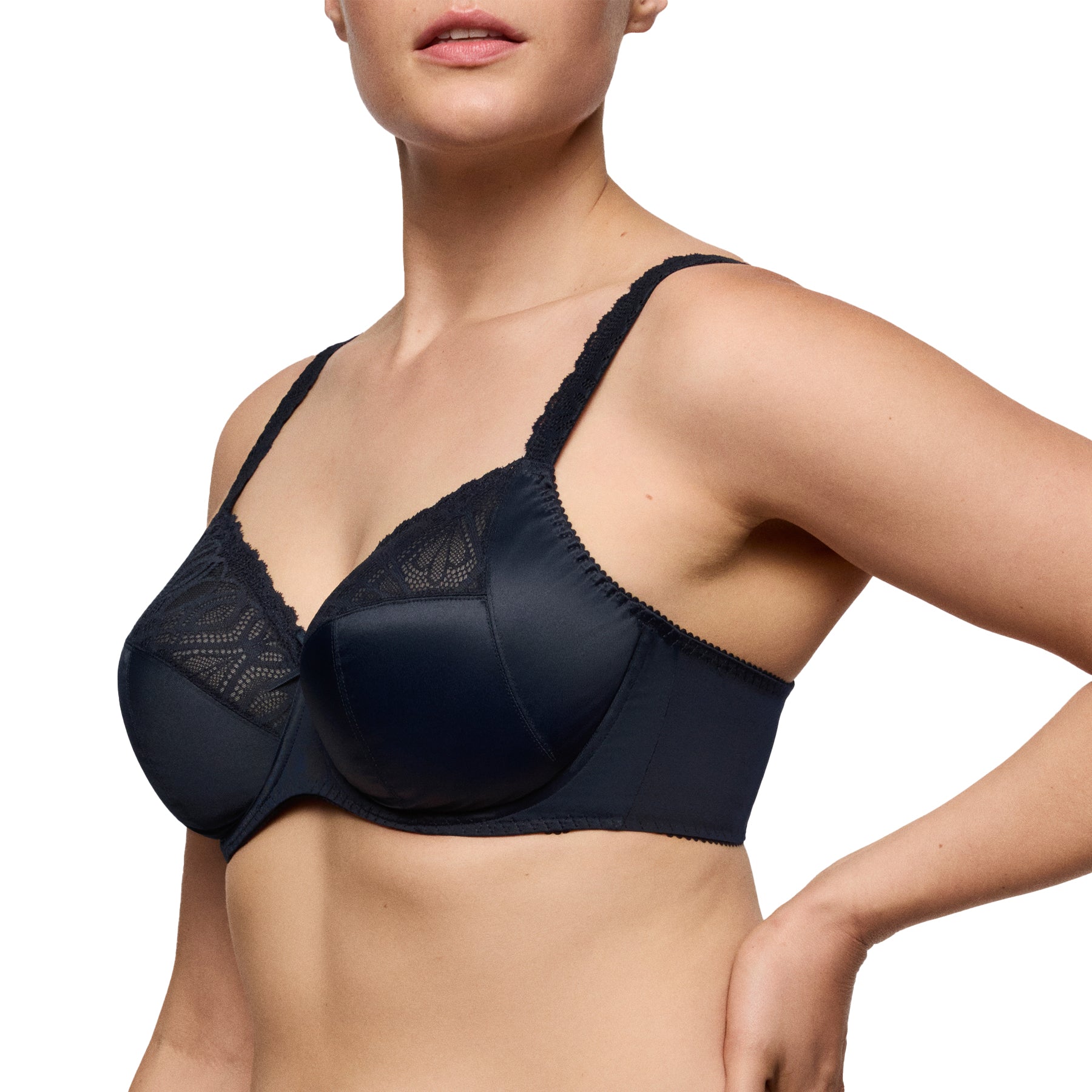 Side view of woman wearing a navy lace underwire bra, showing wide supportive straps and smooth side band.