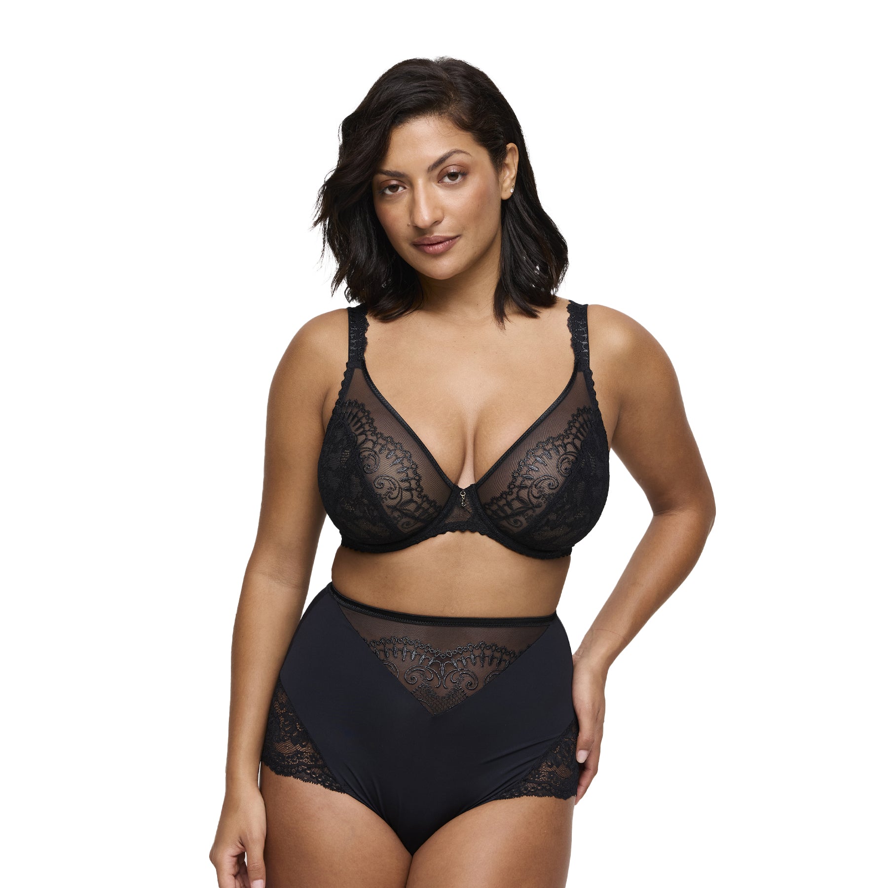 Woman wearing black sheer lace bra and high-waist brief set, front view.