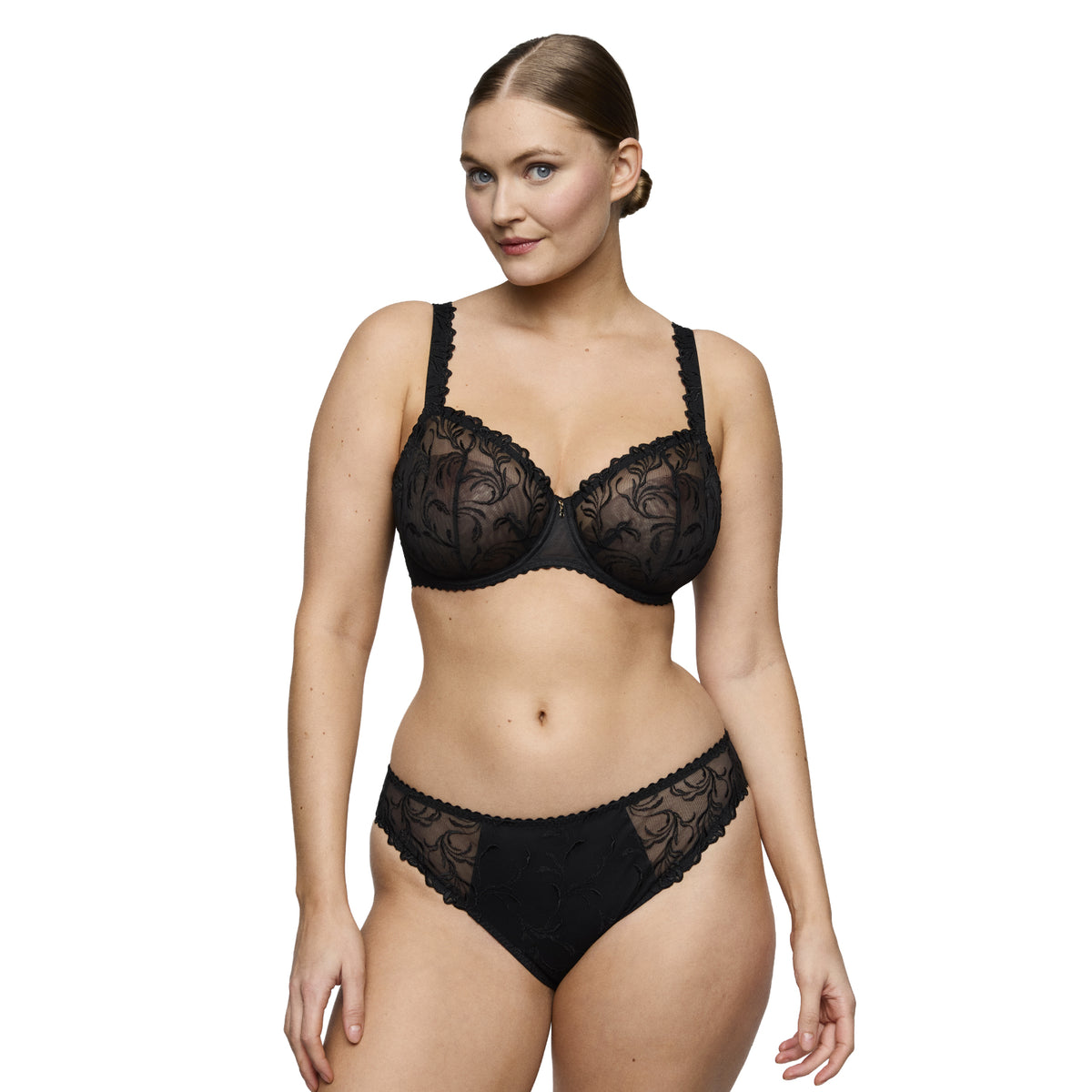 Model wearing the PrimaDonna Solisse balcony bra in black with semi-sheer floral embroidery and matching Rio brief.