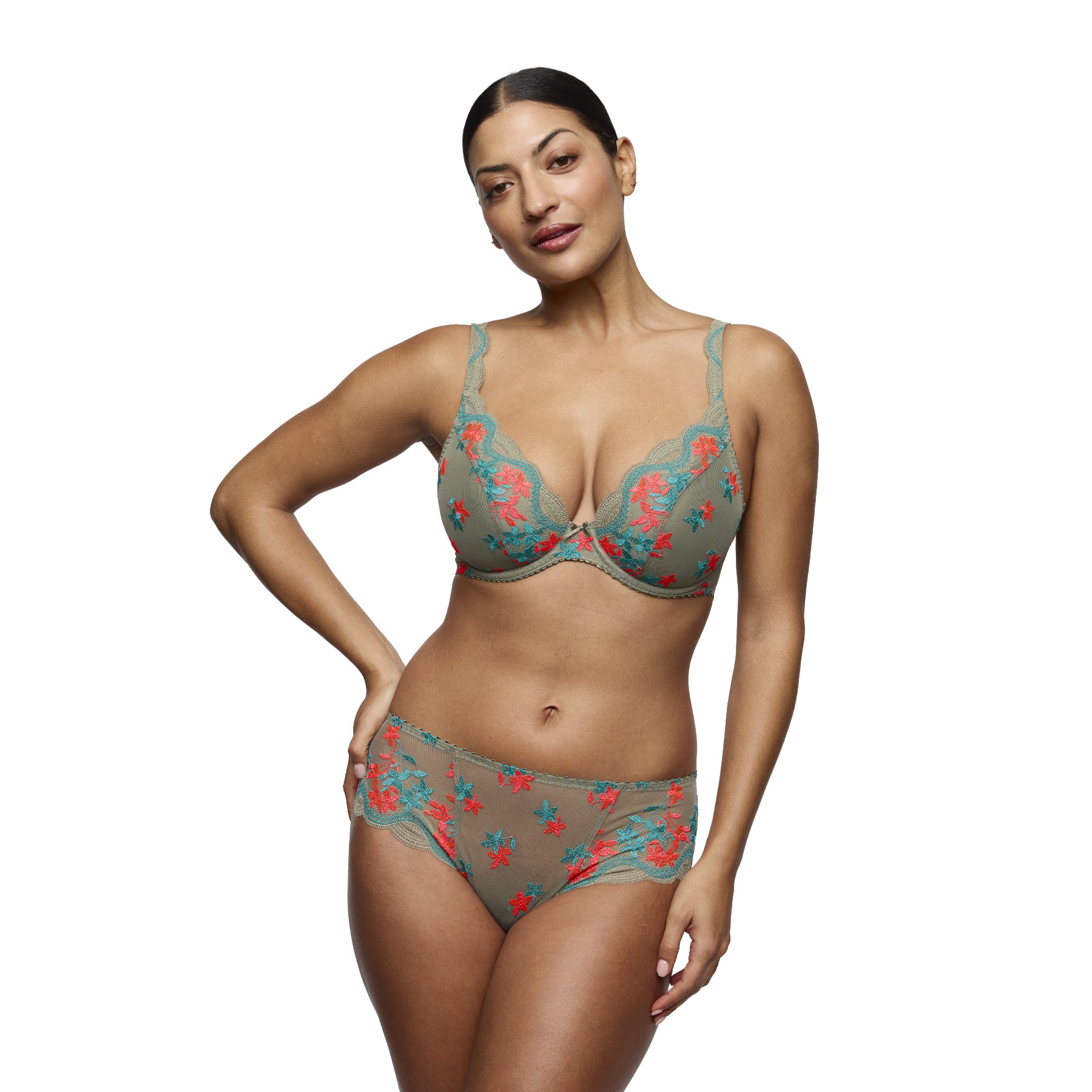 Model wearing PrimaDonna Cala Luna plunge bra and matching full brief in Botanique, featuring vibrant coral and turquoise floral embroidery on a khaki base.
