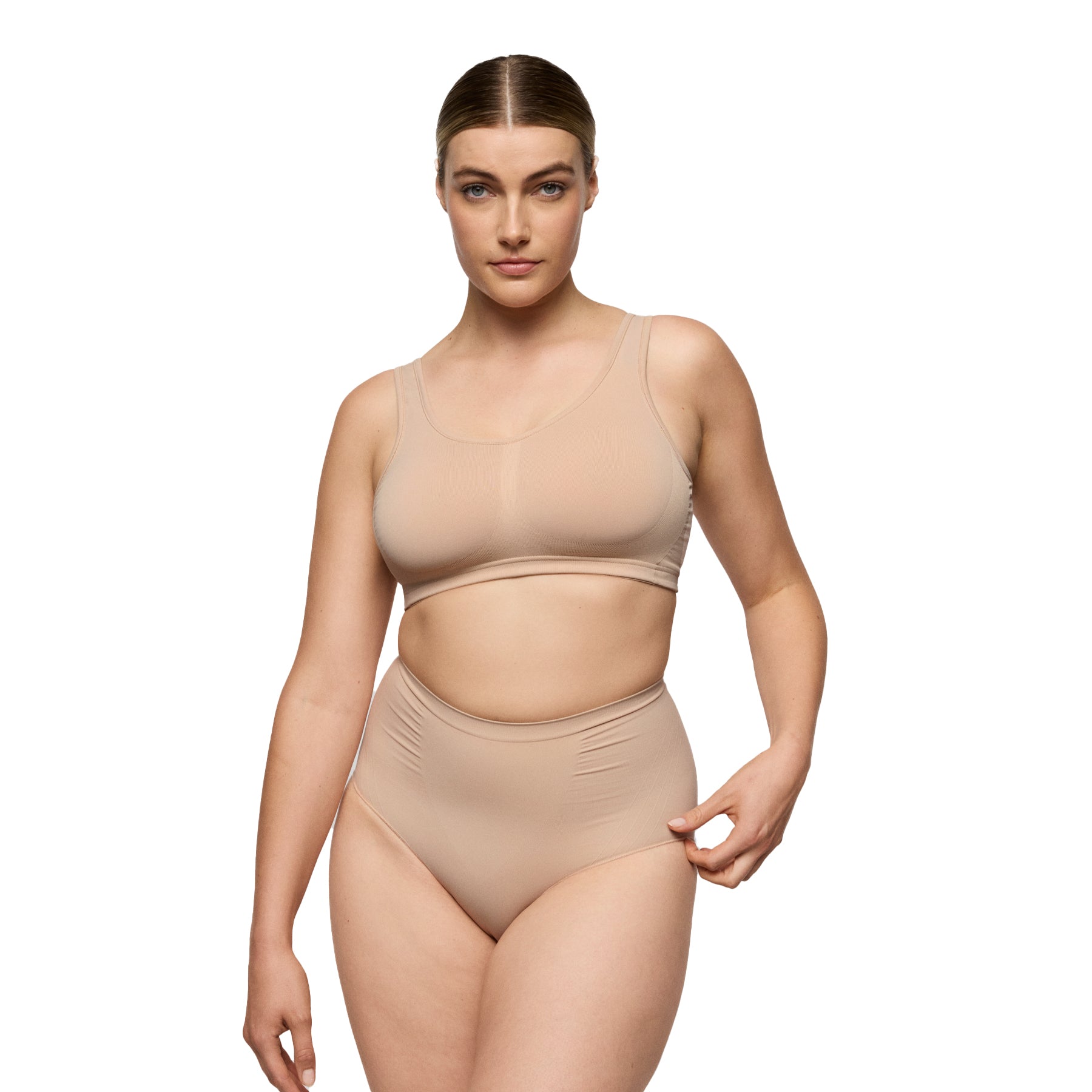 Model standing in nude seamless bra and high-waisted shaping brief, front view