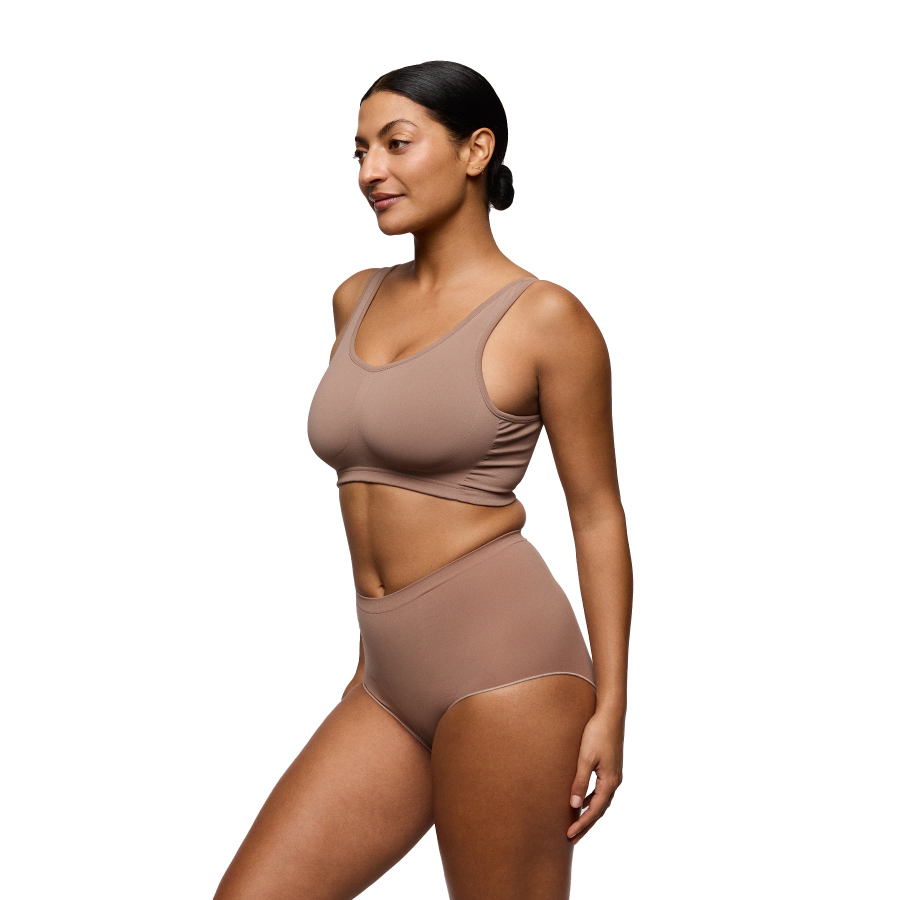 Model wearing mocha seamless bra and high-waisted shaping brief, angled front view
