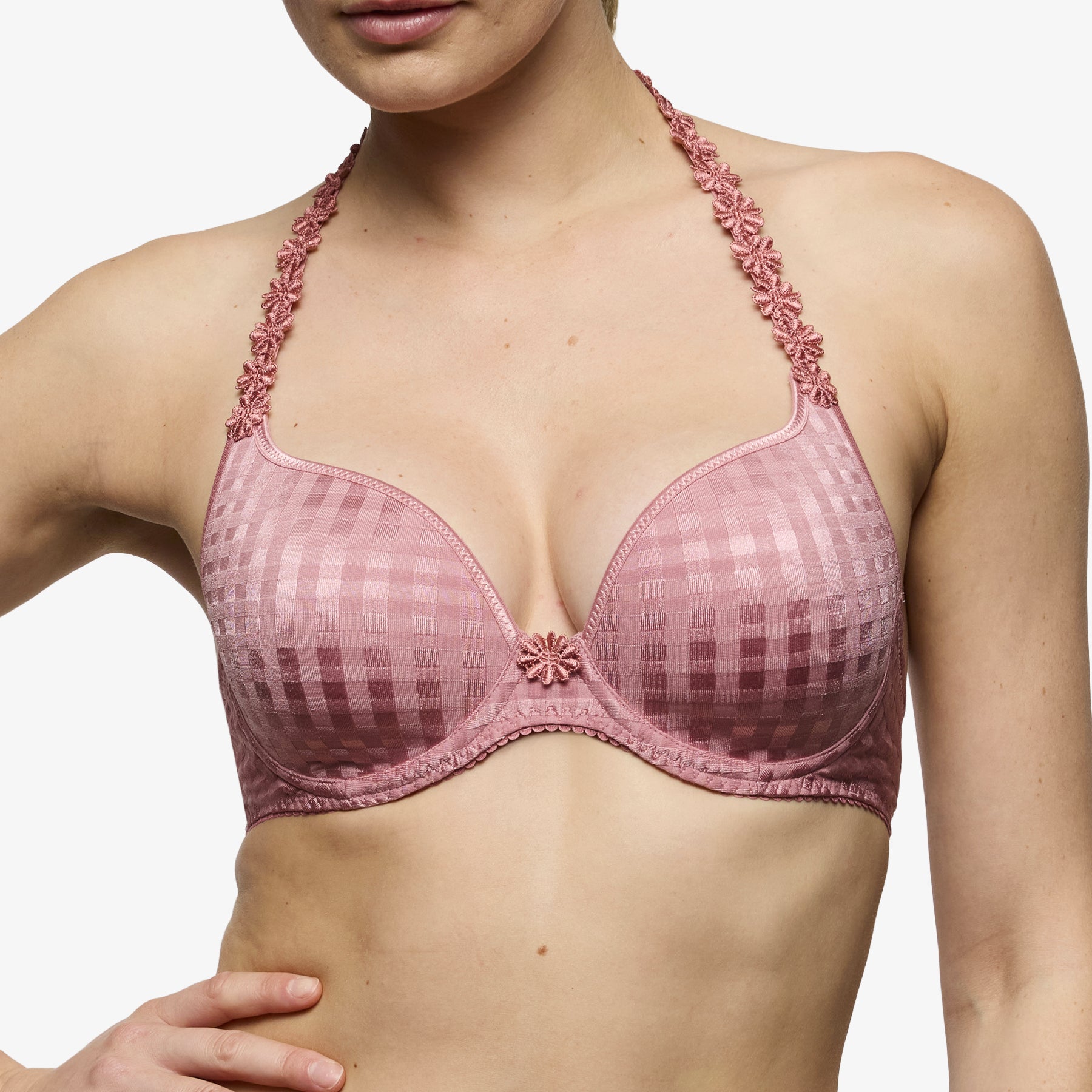 Pink plunge bra on model with deep neckline and floral strap detailing