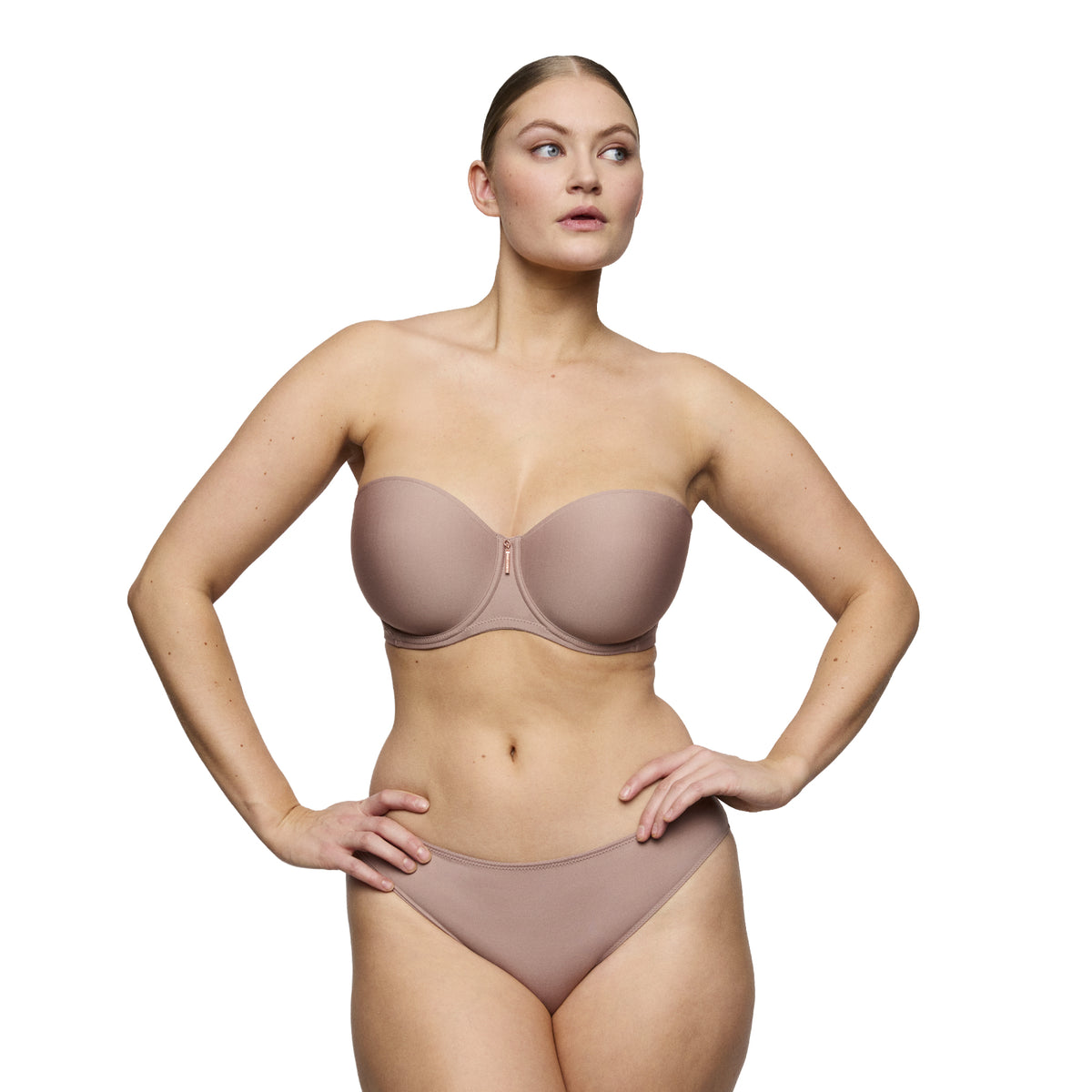 Model wearing the Strapless Twist bra in Cosmetic with smooth molded cups and matching brief.