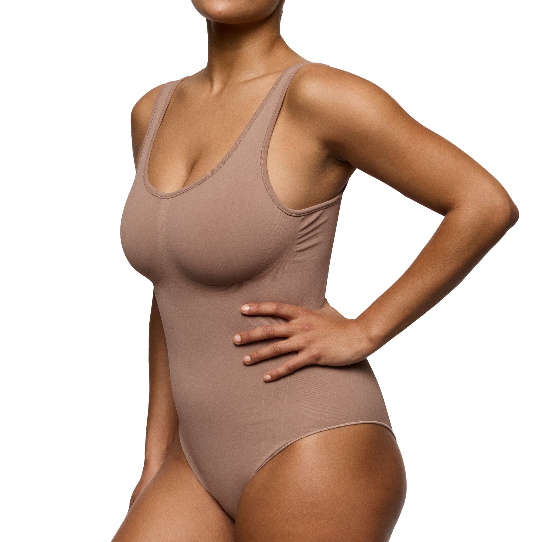 Side angled view of mocha seamless minimizer bodysuit showing waist sculpting and smooth finish