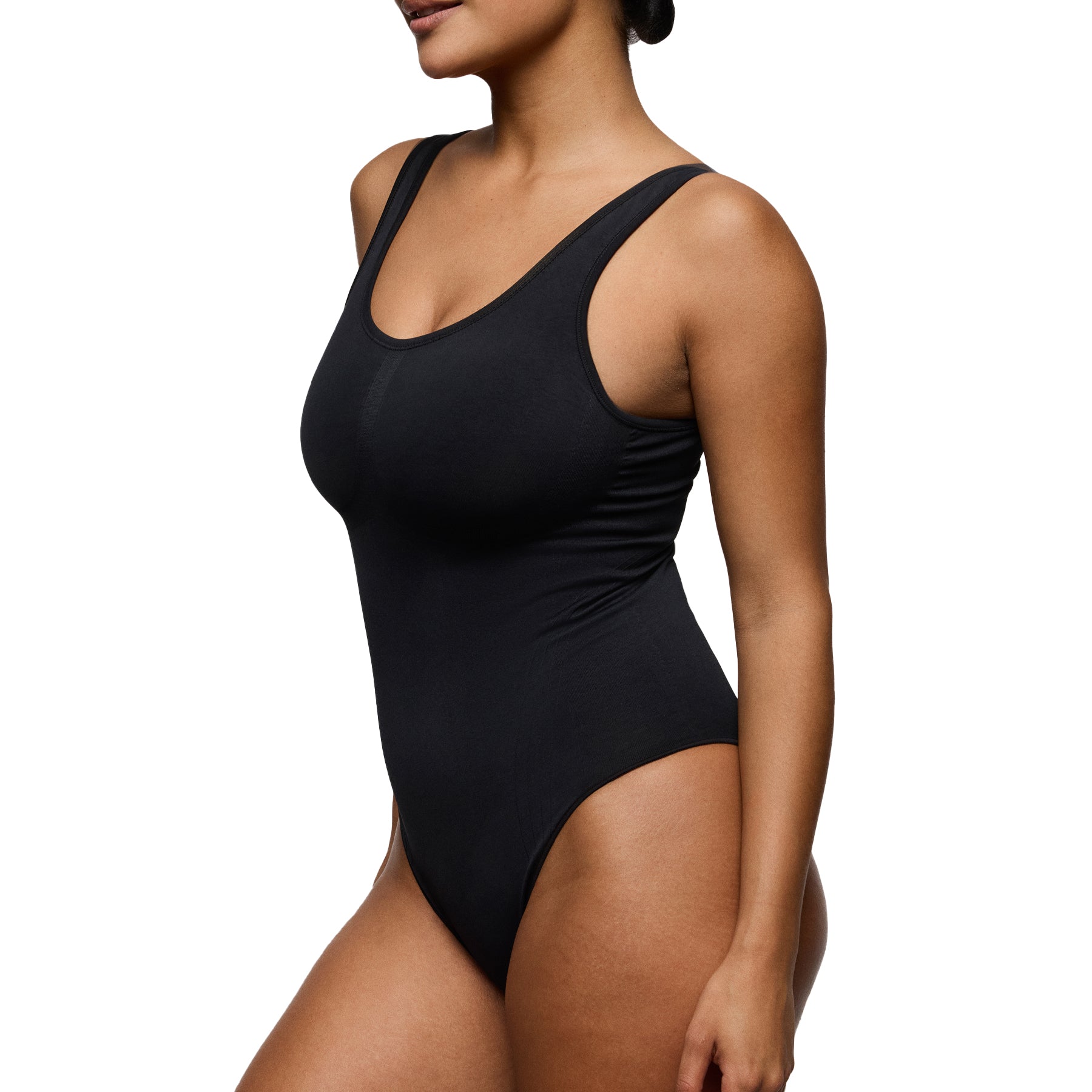 Side angled view of black seamless shaping bodysuit highlighting waist contouring and smooth silhouette