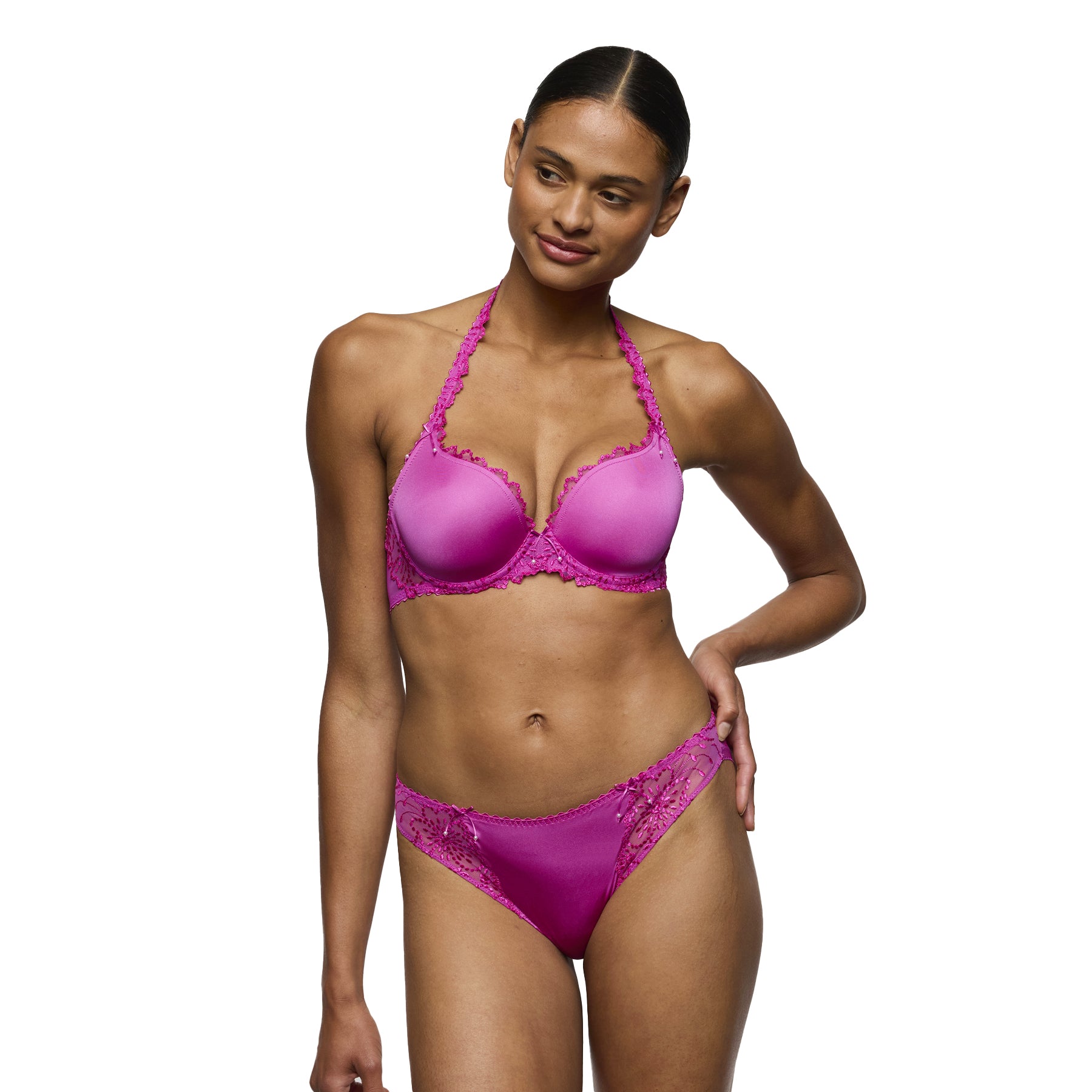 Full-body front view of model wearing fuchsia lace underwire bra and matching rio brief.