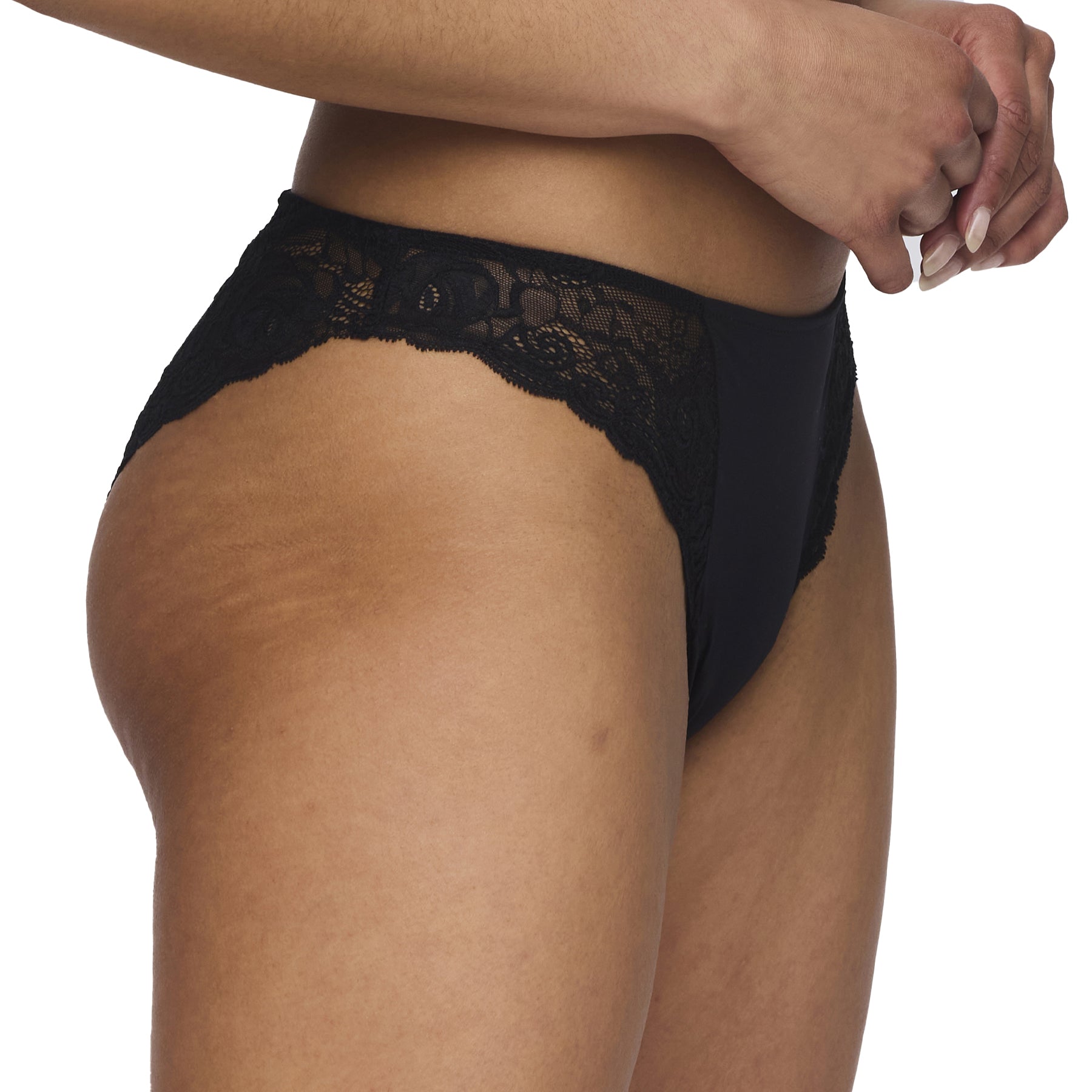Side view of a model wearing a black bikini brief showcasing scalloped lace edging.