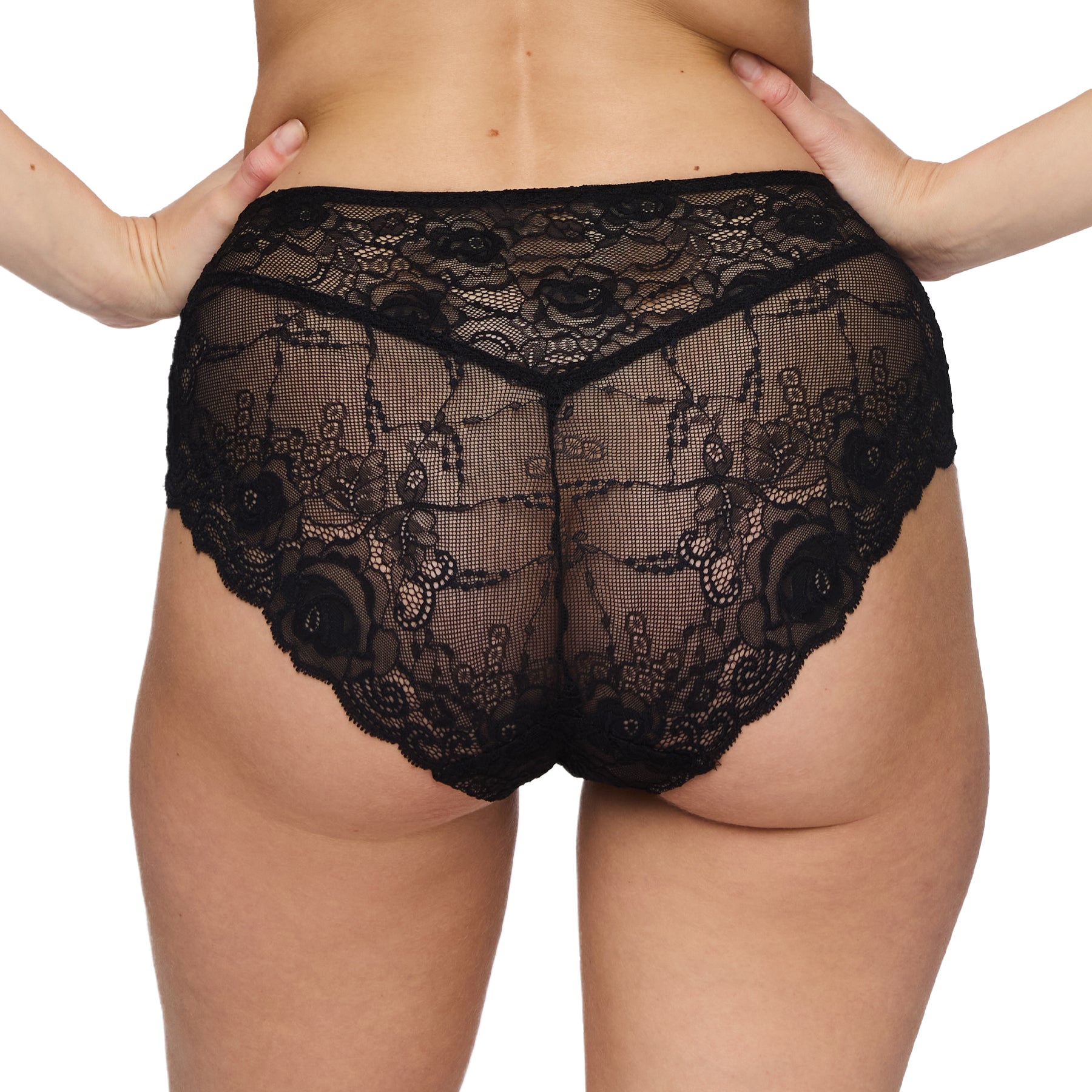 Back view of a woman wearing black high-waisted lace panties with floral embroidery and scalloped edges.