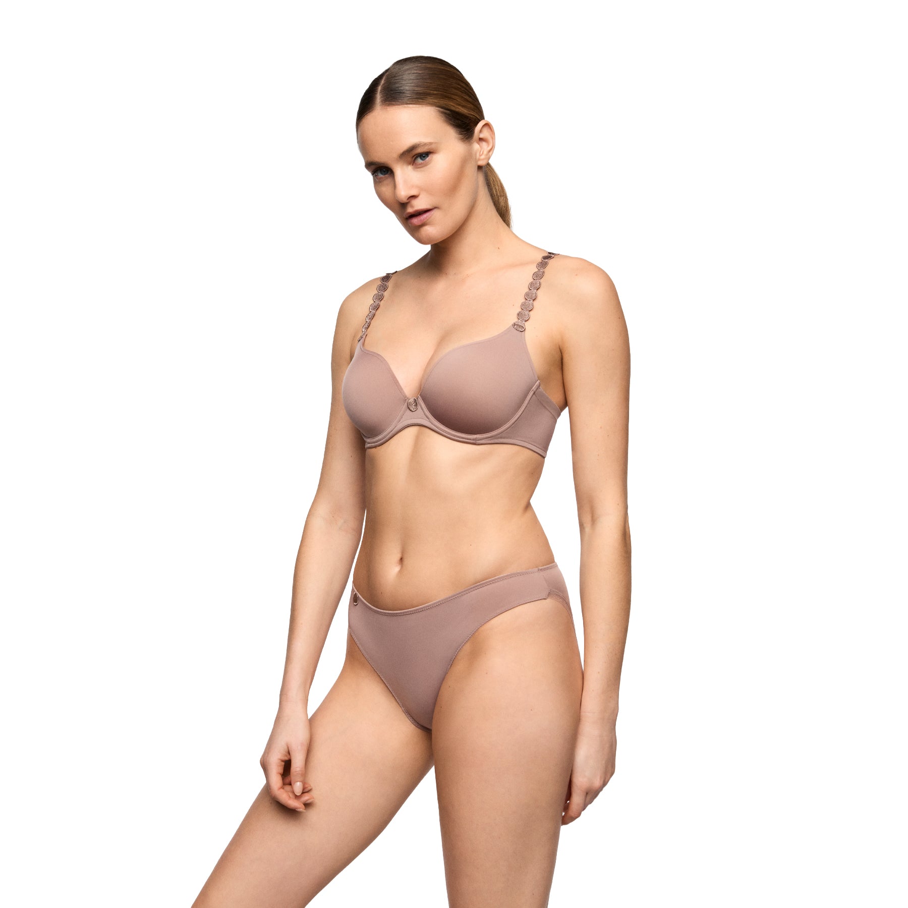 Cosmetic nude bikini brief styled with matching bra, featuring a smooth finish and delicate side detail.