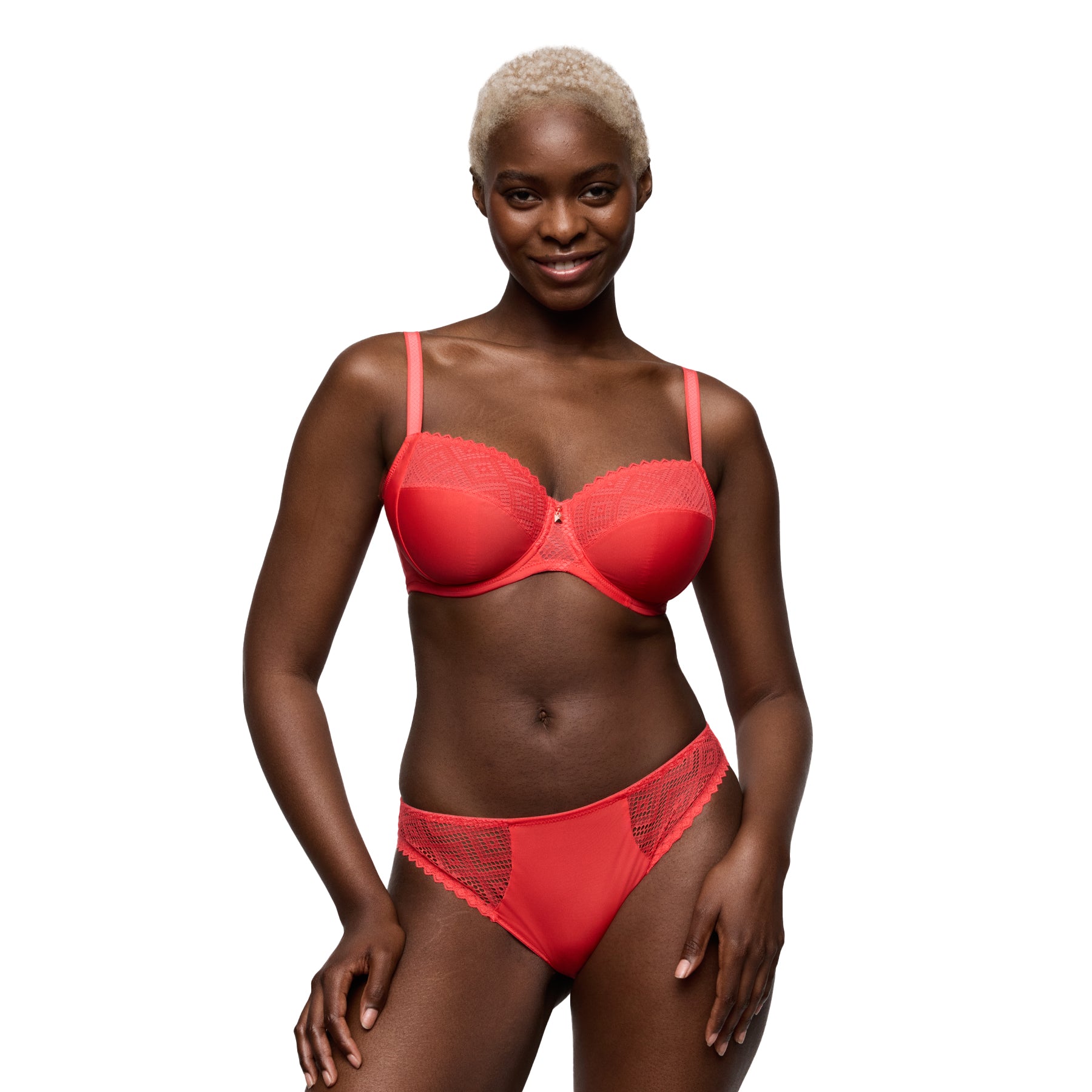 Model wearing a coral underwire bra with matching mid-rise brief, featuring smooth fabric and lace detailing, front view.