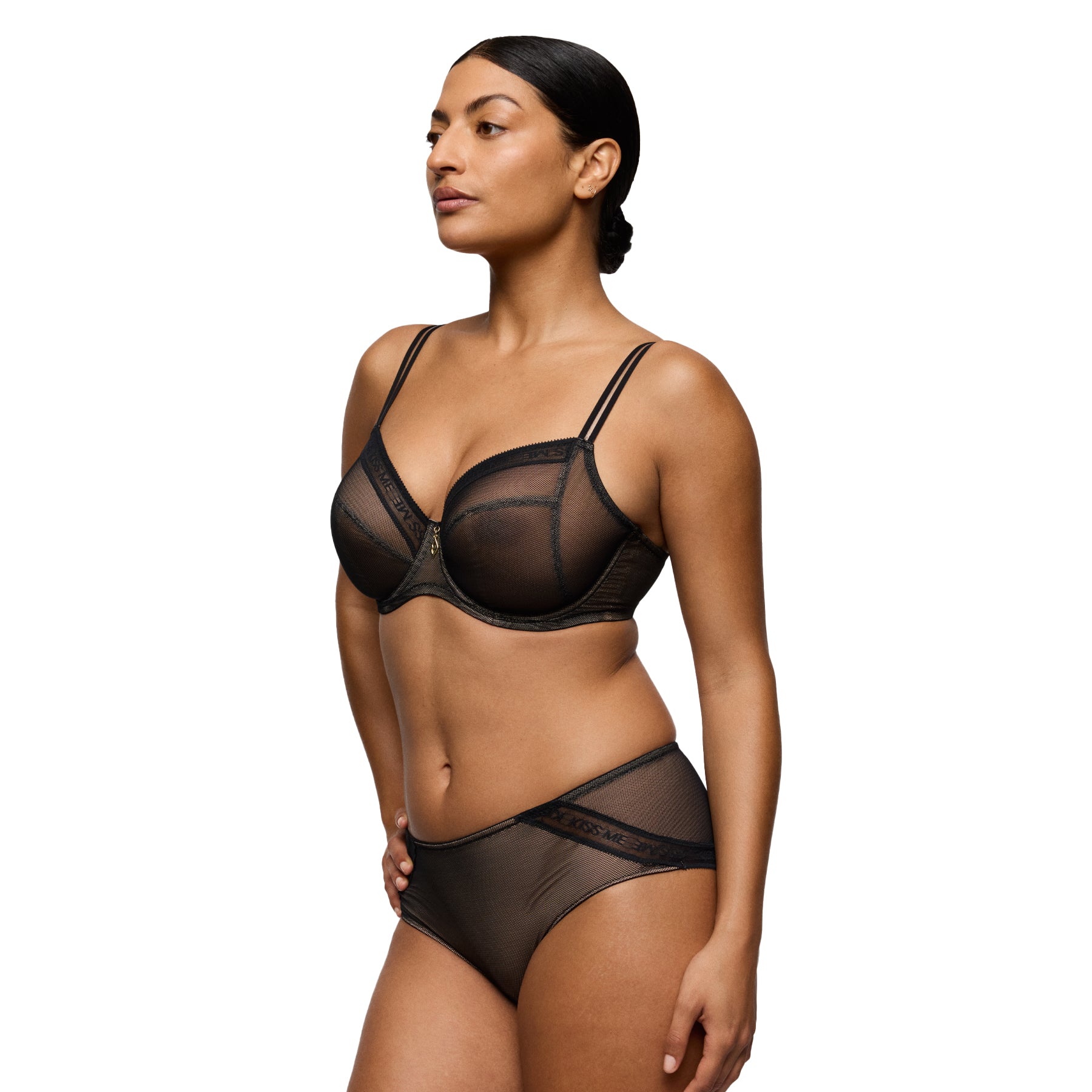 Model wearing a black sheer mesh underwired bra with subtle branded trim and a delicate gold charm at the centre.