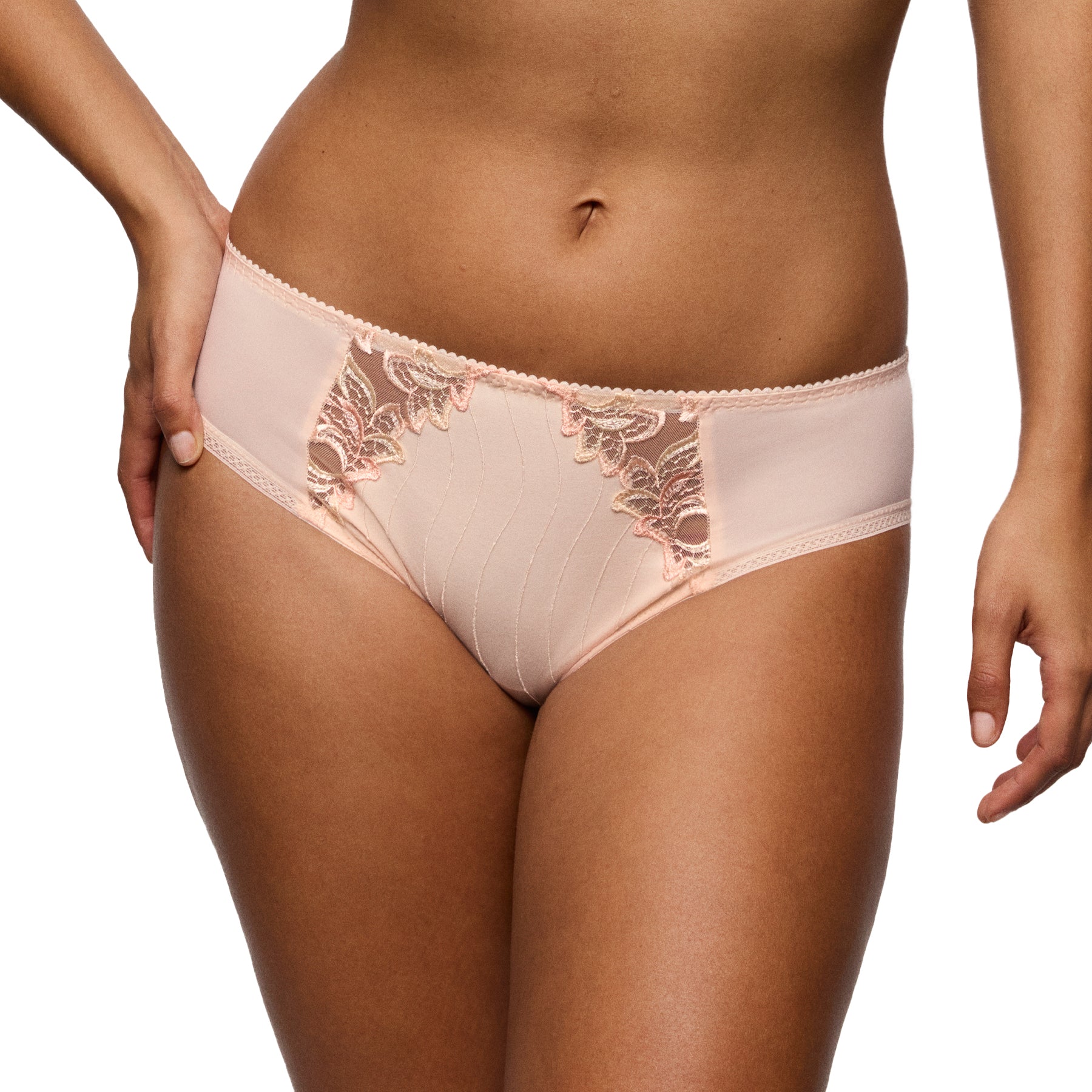 Front view of a nude mid-rise brief worn by a model, highlighting the lace accents and smooth, flattering fit.