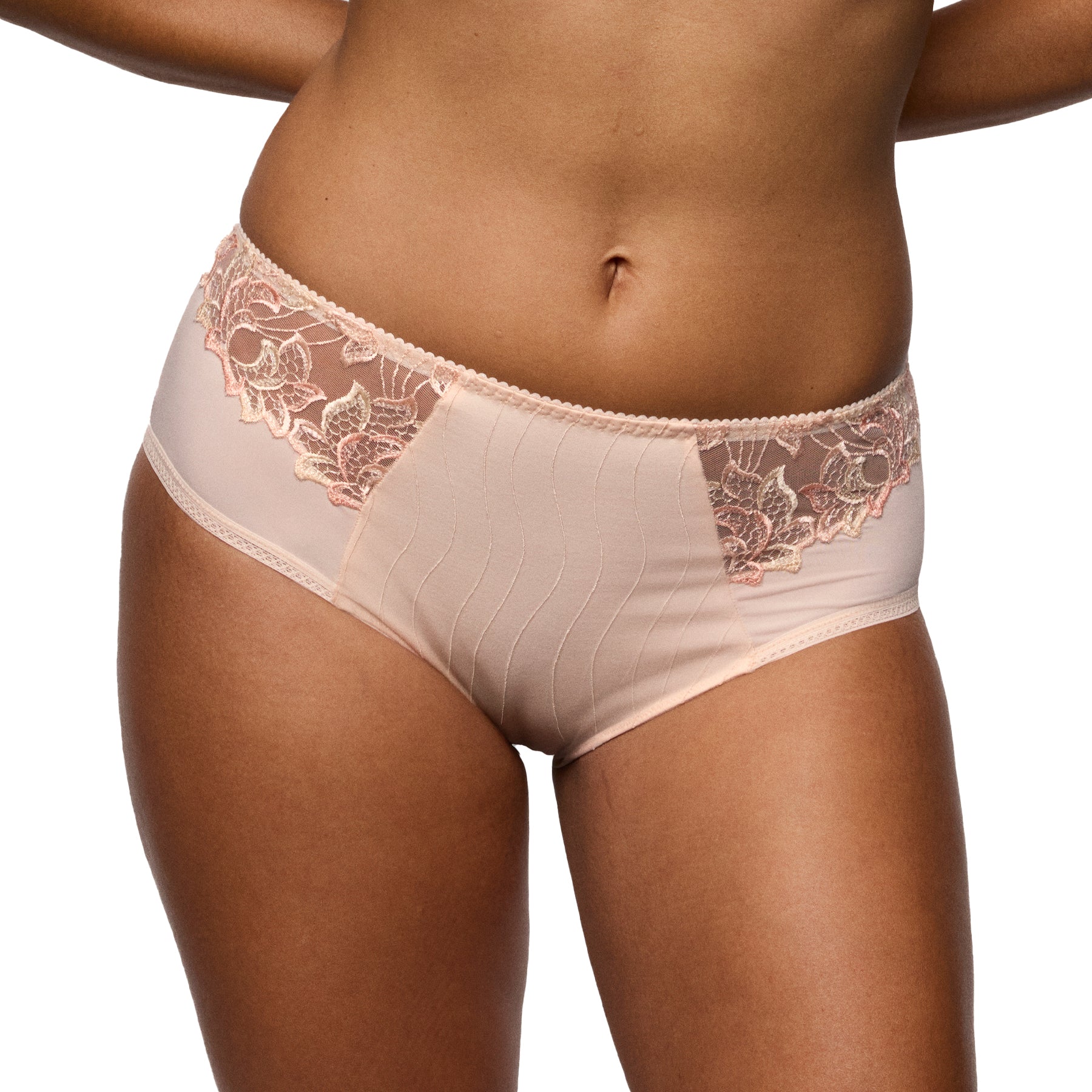 Front view of a blush lace full brief on a model, highlighting the flattering cut, soft fabric, and elegant embroidery.