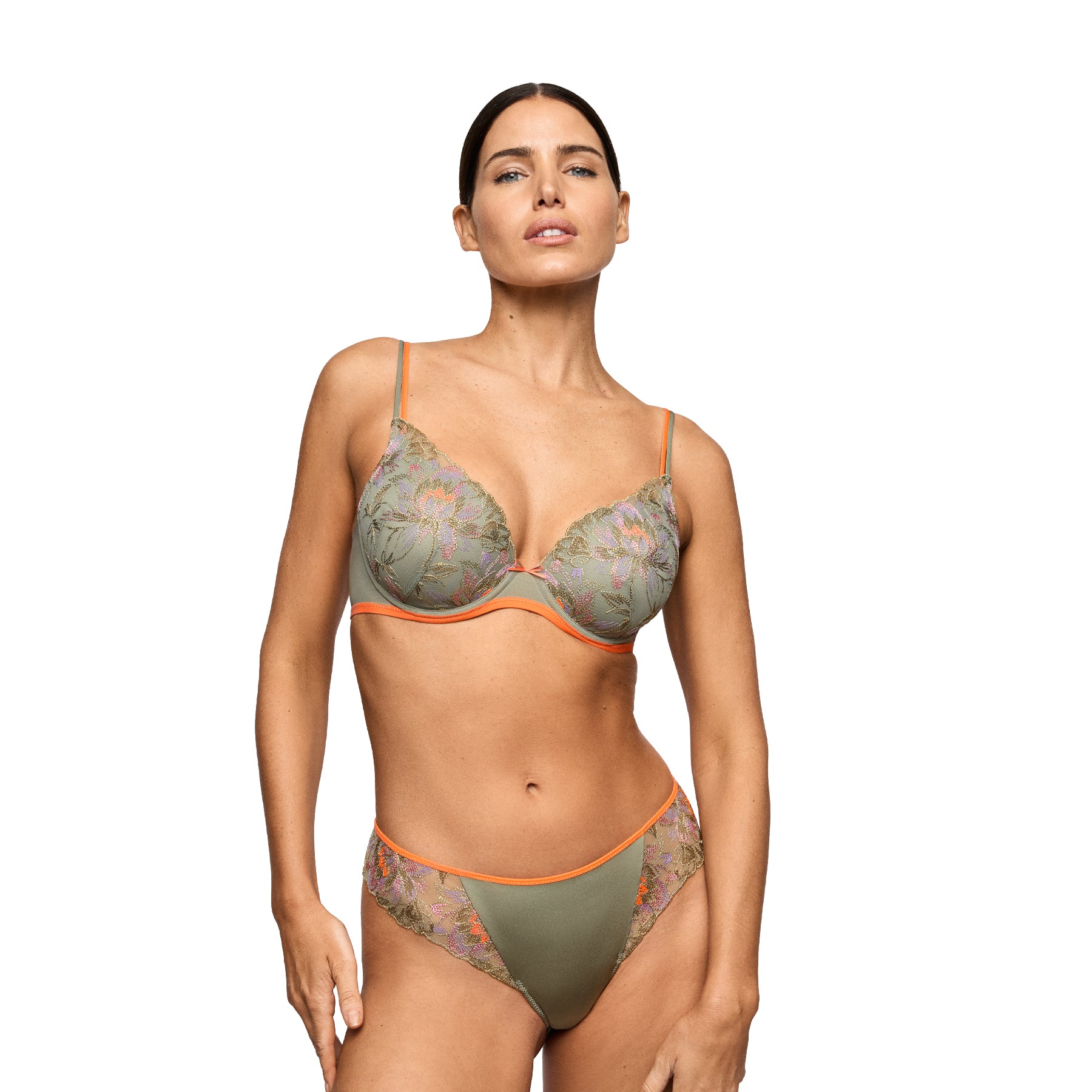 Model wearing an olive green embroidered plunge bra with matching bikini brief, accented with bright coral trim.