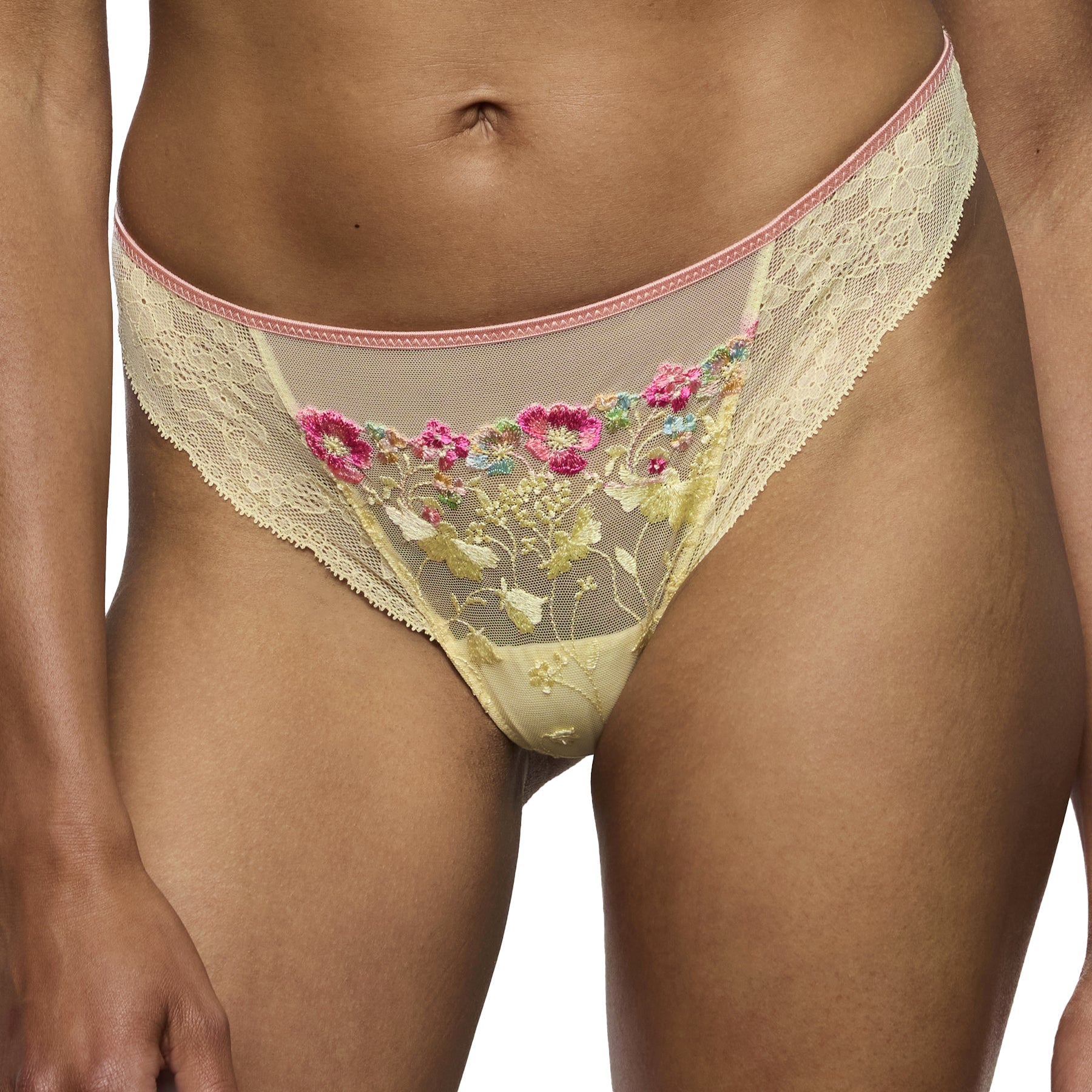 Front view of French vanilla thong with vibrant pink floral embroidery and sheer mesh panels on model.