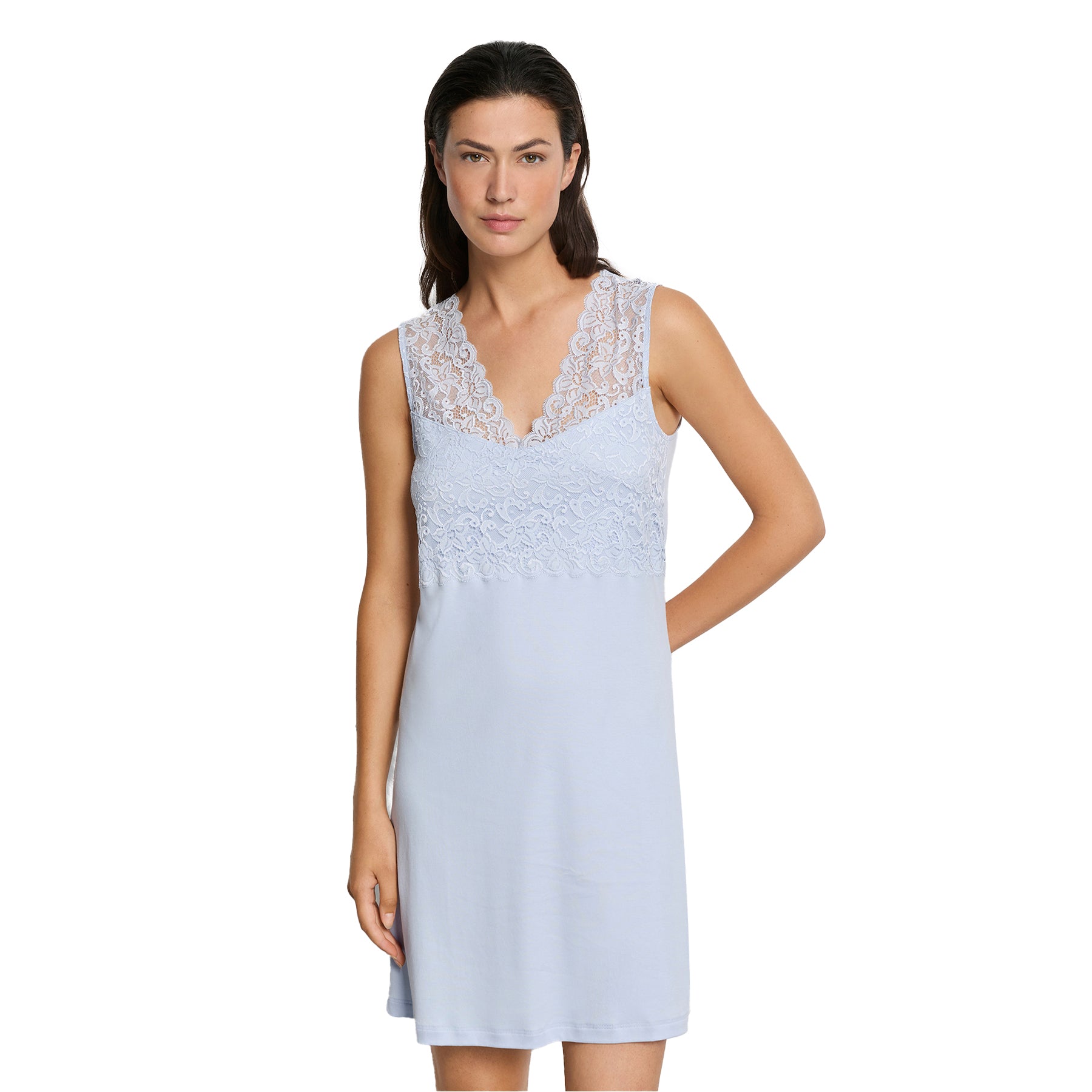 Woman wearing light blue lace nightgown with floral lace top and soft drape silhouette, knee-length design