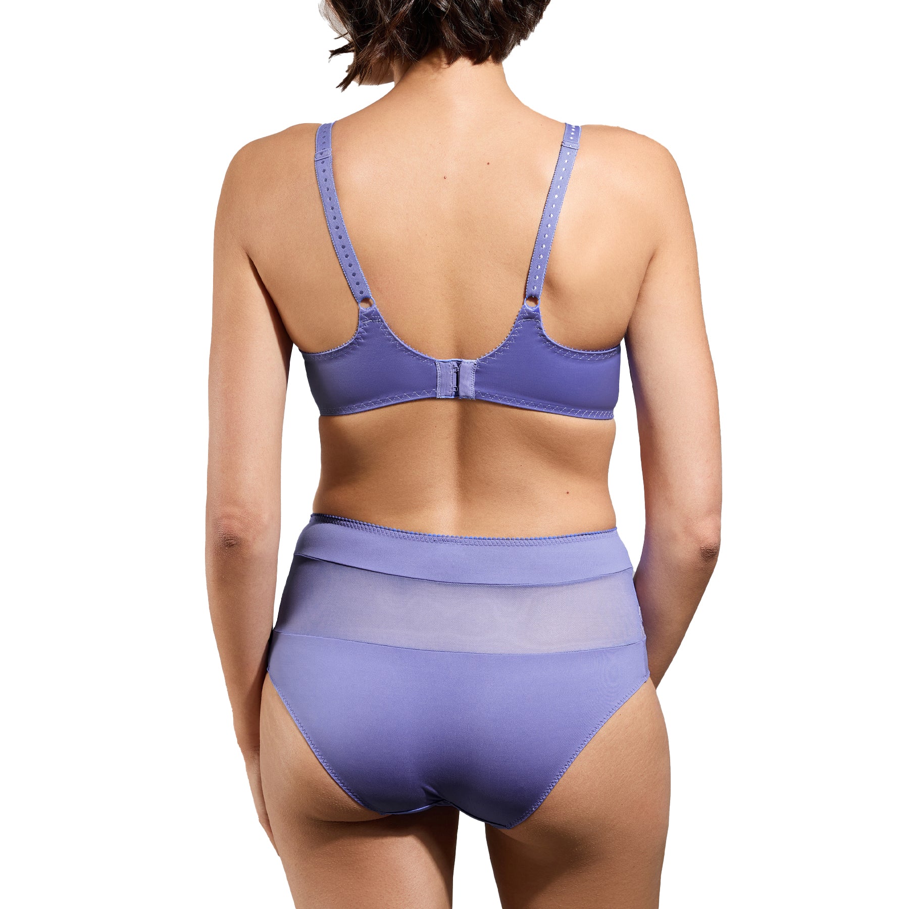 A back view of the model wearing the lavender lace bra and high-waisted panties, showing adjustable straps, a hook-and-eye closure, and a smoothing fit.