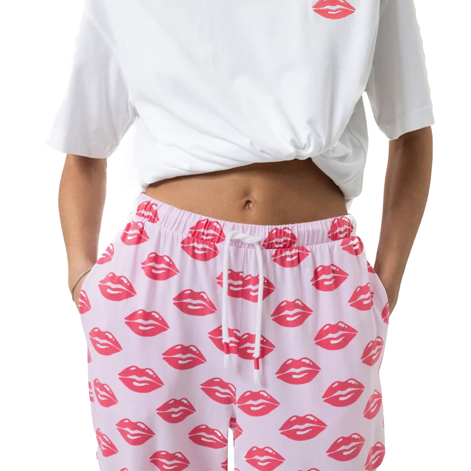 Close-up of jogger pants with elastic waist and drawstring, printed with red lips on pink background.