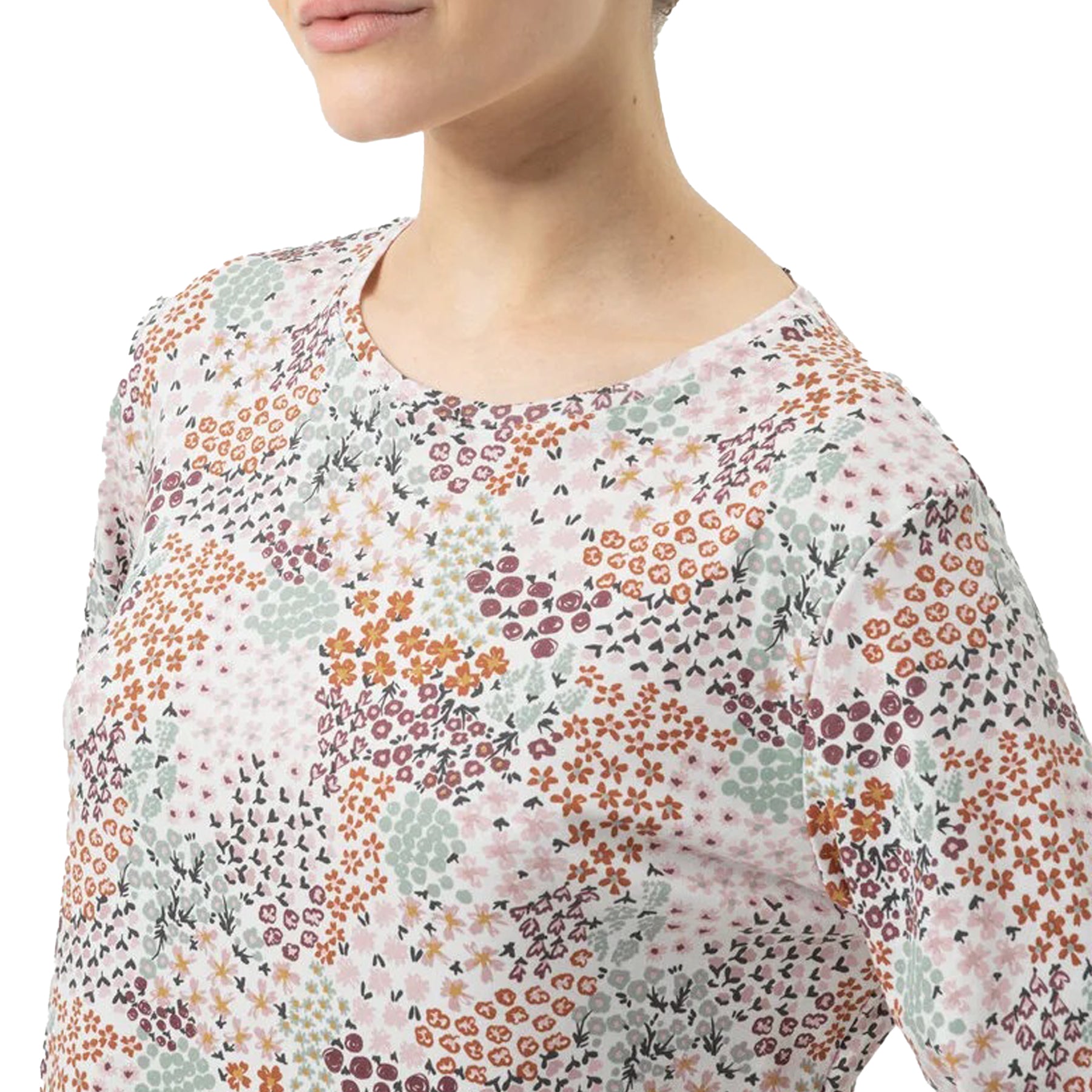 Close-up of floral patchwork print on cotton nightshirt in pink, orange, green, and burgundy tones.
