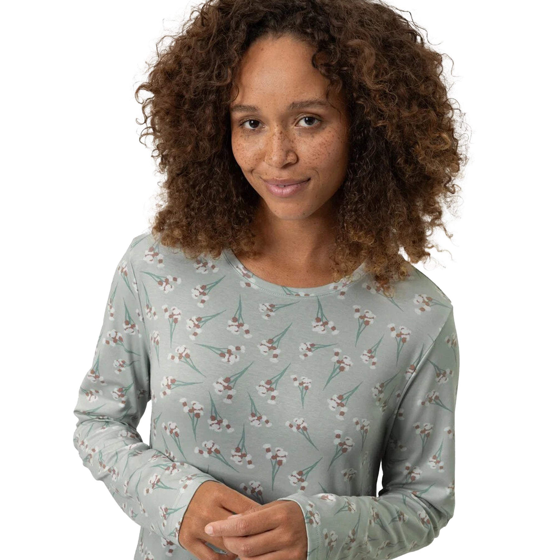 Detailed look at the neckline and floral print of the sage green nightshirt.