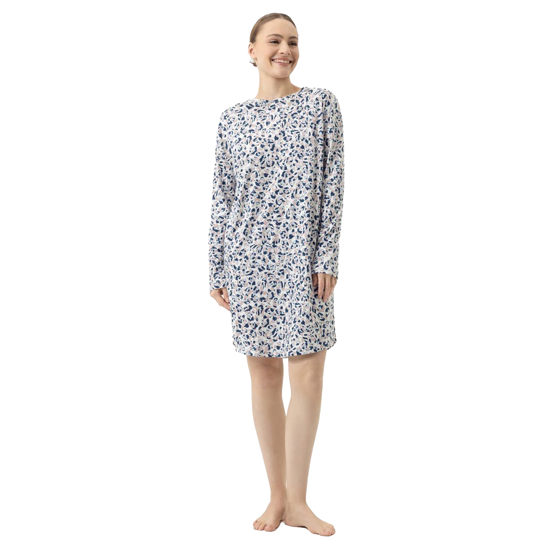 Woman smiling in a white long-sleeve nightgown with navy and beige abstract print.