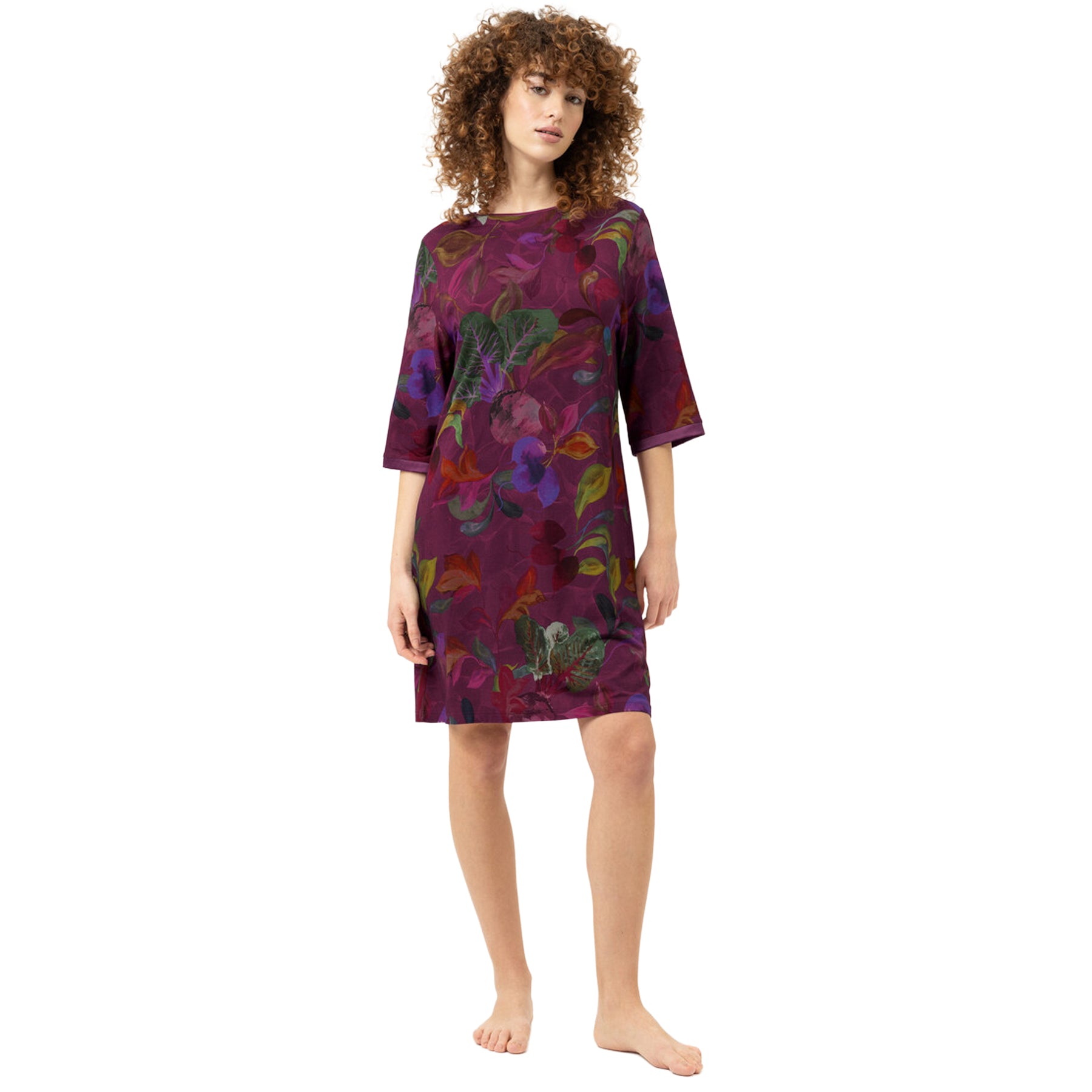 Model wearing the Mey Crushed Berry sleepshirt featuring a rich berry botanical print, relaxed knee-length fit, round neckline, and elegant three-quarter sleeves.