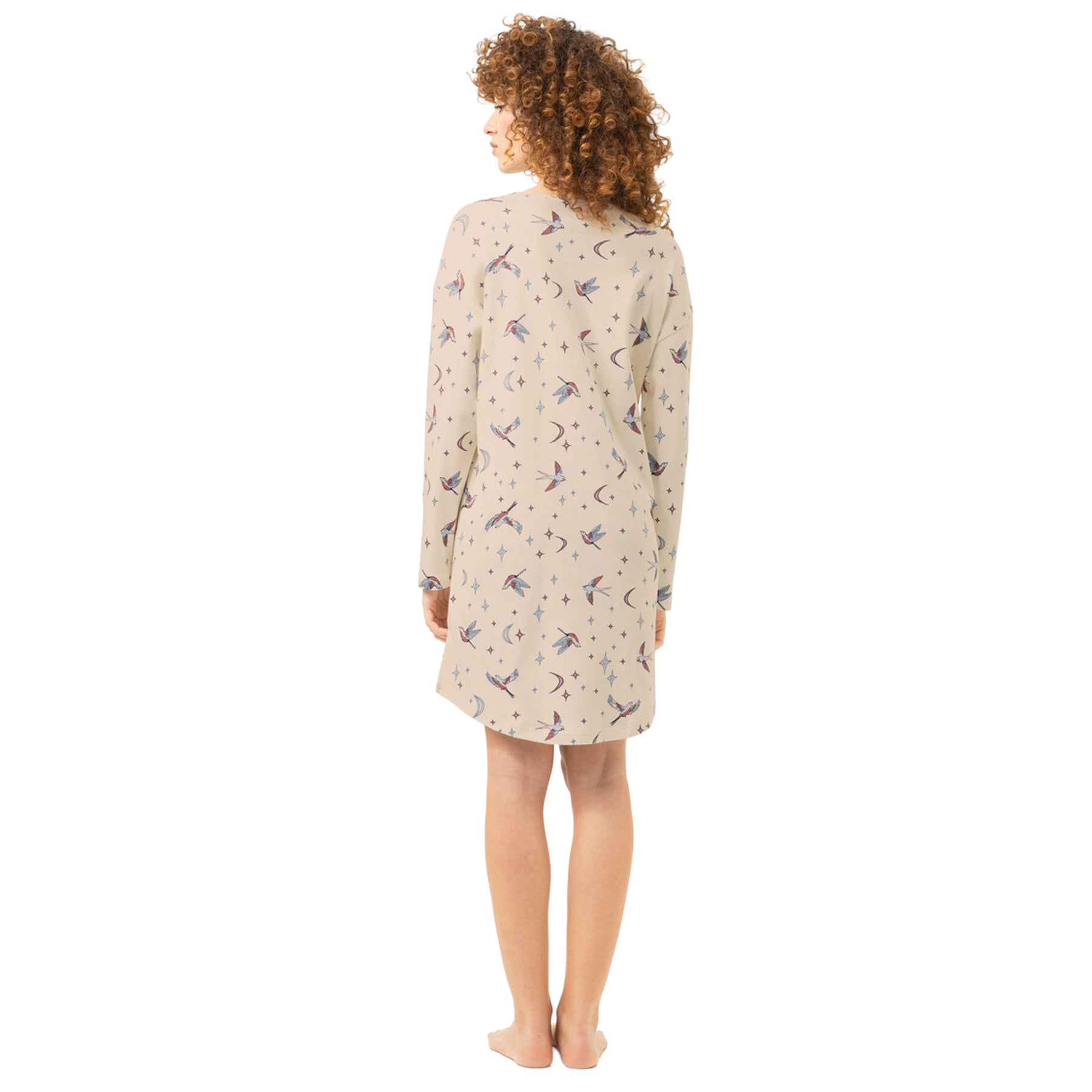 Back view of cream long-sleeve nightgown featuring a whimsical bird, moon and star print and knee-length silhouette.