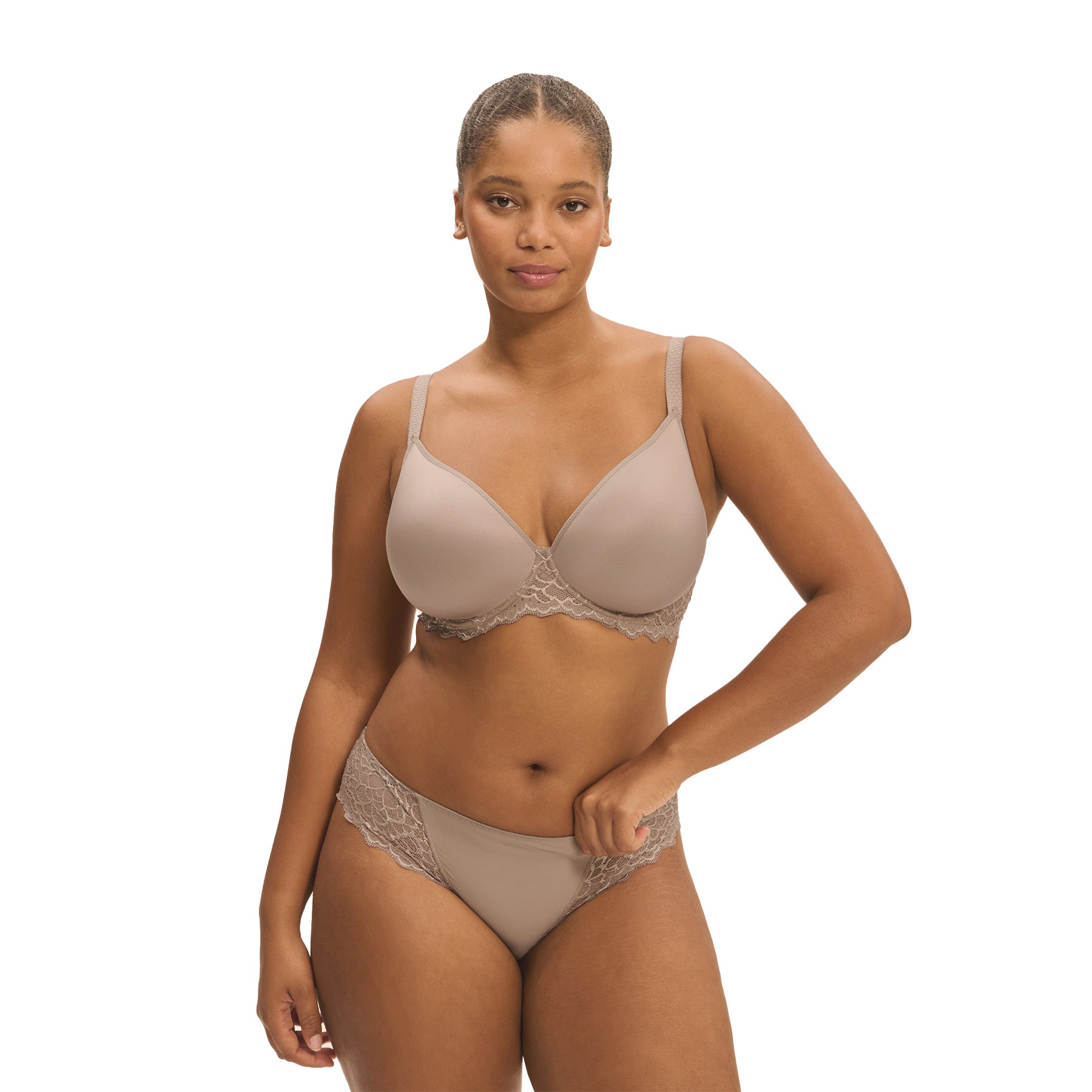 A model showing a grey/nude set of lacey basic lingerie from Simone Perele on a white background.